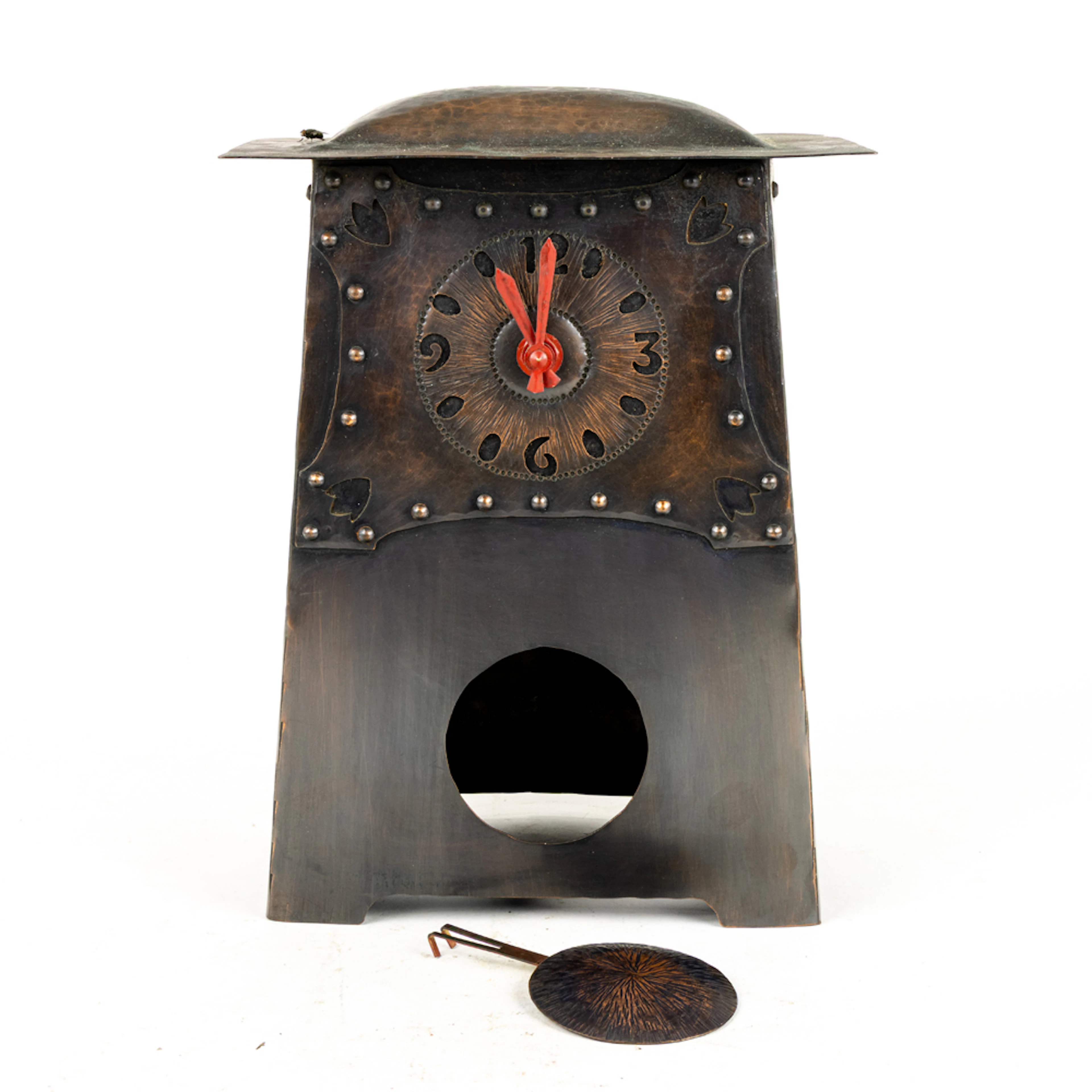 An Arts and Crafts style hammered copper mantel clock