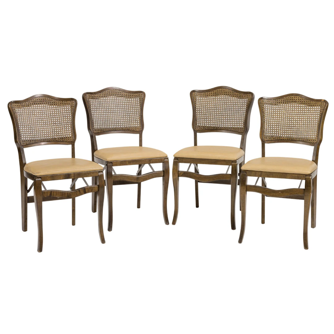 A set of four Provincial style cane back folding chairs