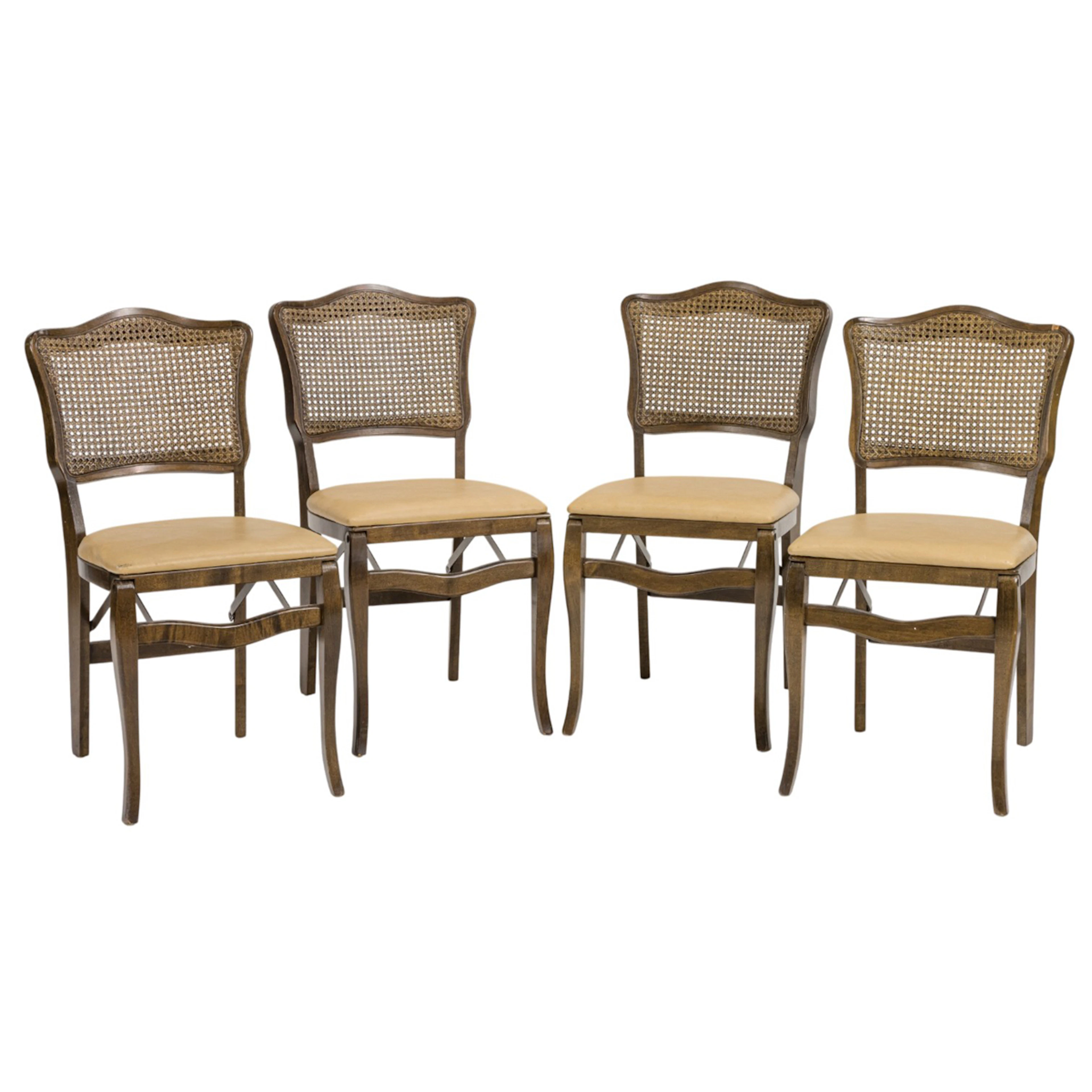A set of four Provincial style cane back folding chairs