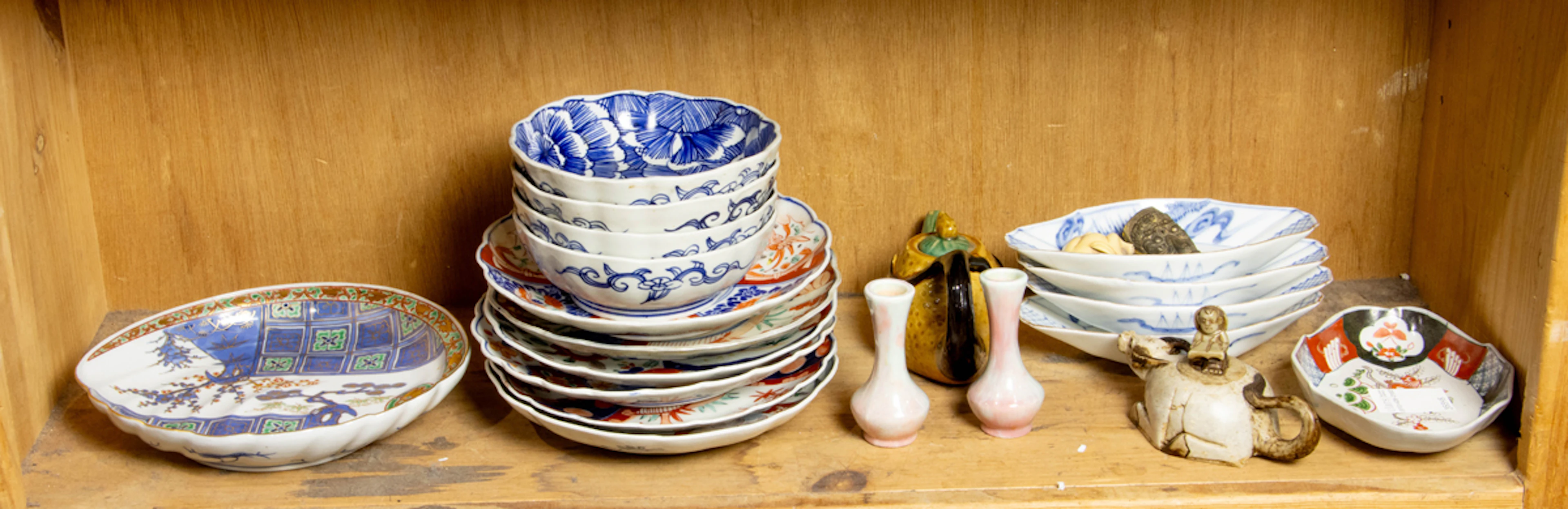 A shelf of Asian decorative objects