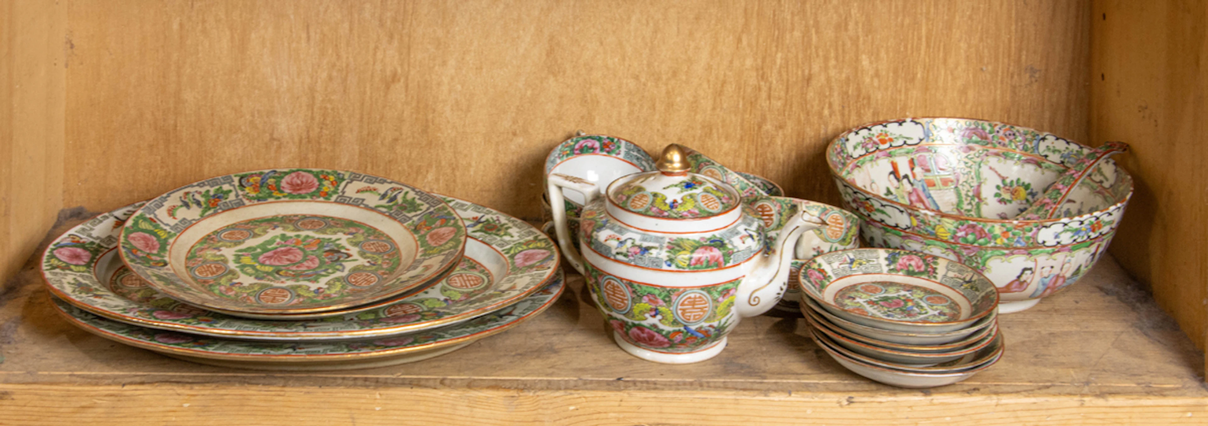 A shelf of Chinese Canton rose medallion tea and dinner service ware
