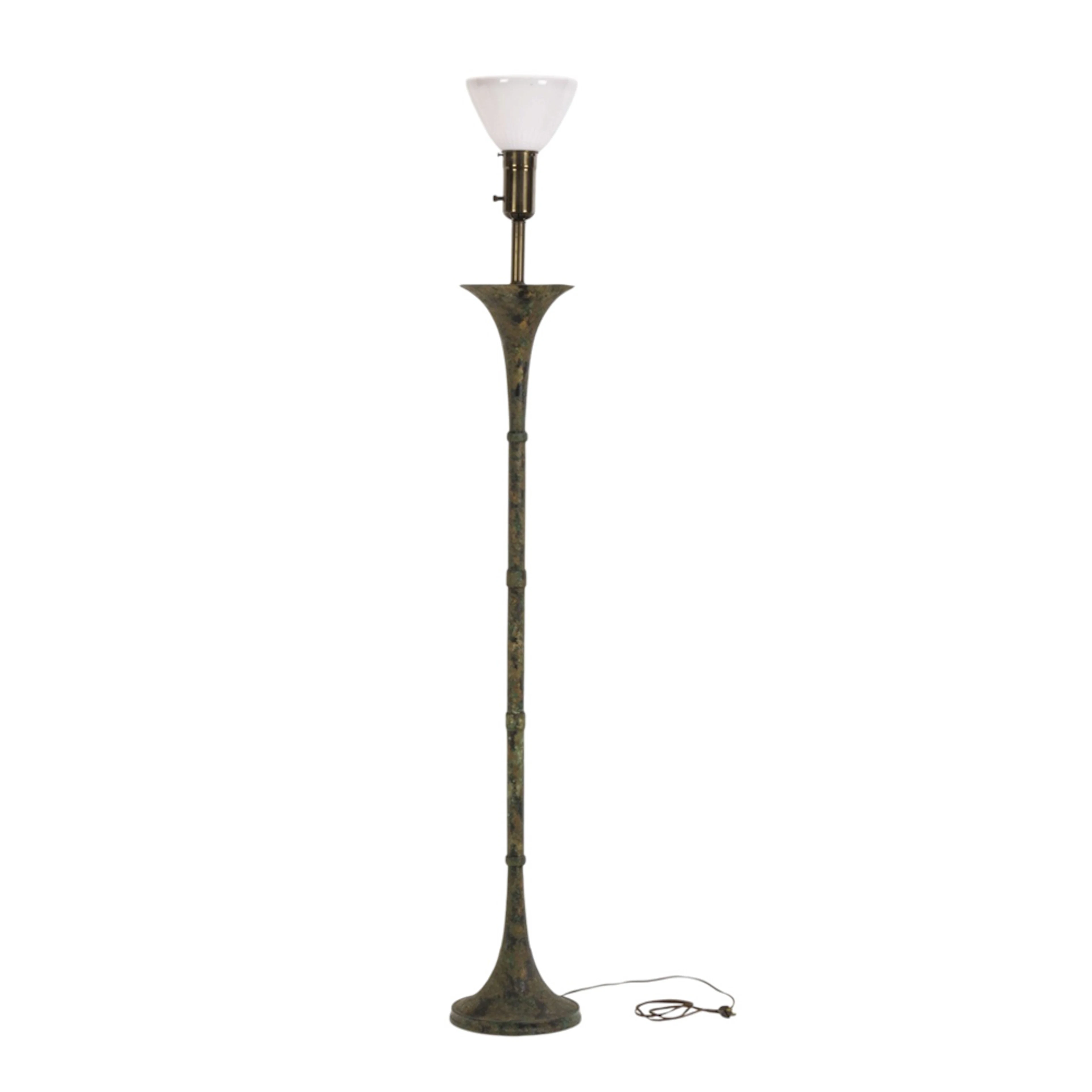 A contemporary verdigris patinated floor lamp in the style of Stewart