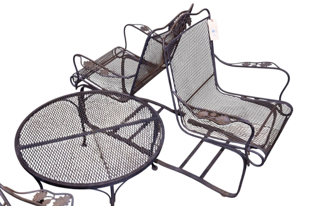 A three-piece wrought iron outdoor patio set