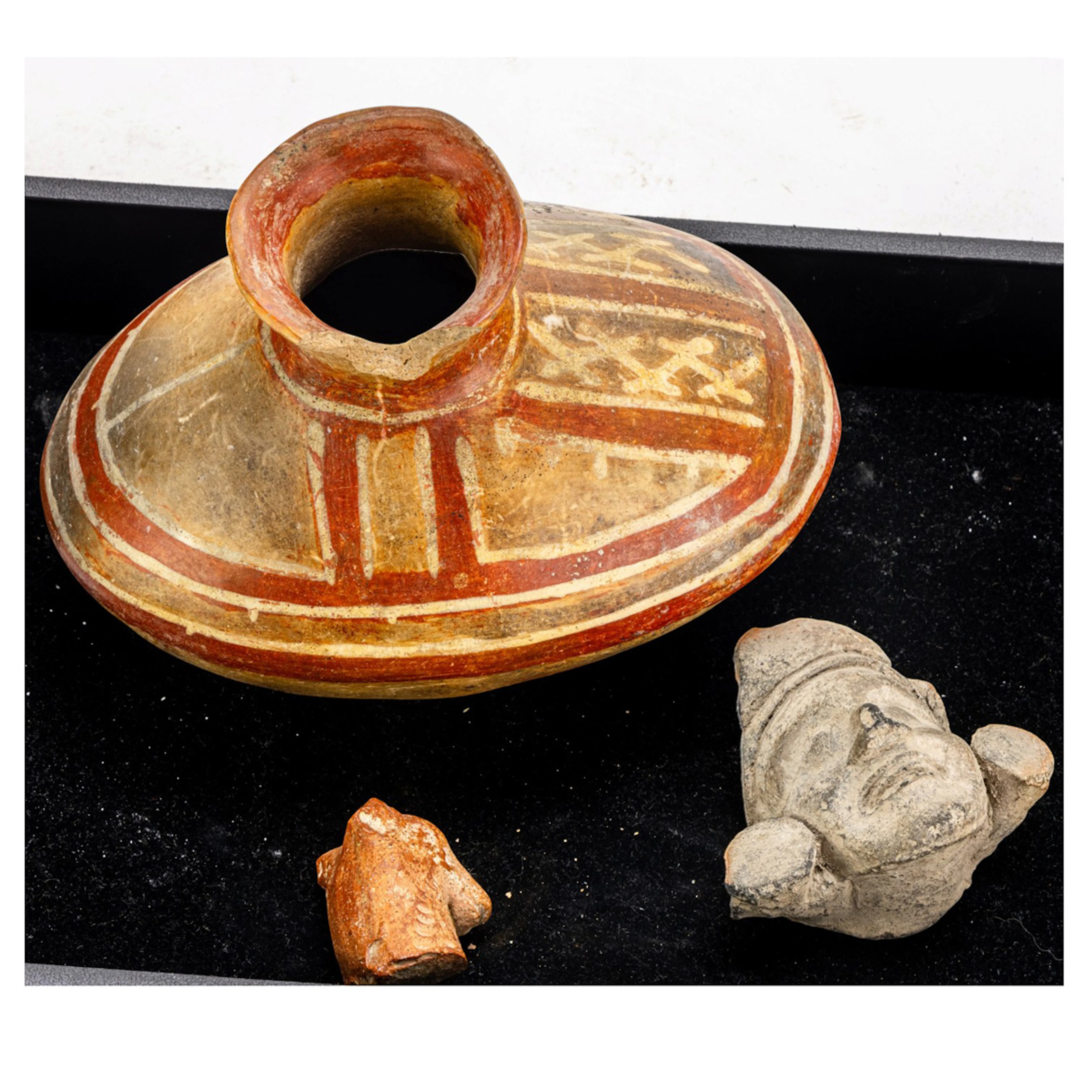 A Pre-Columbian polychrome pottery vessel and pottery head