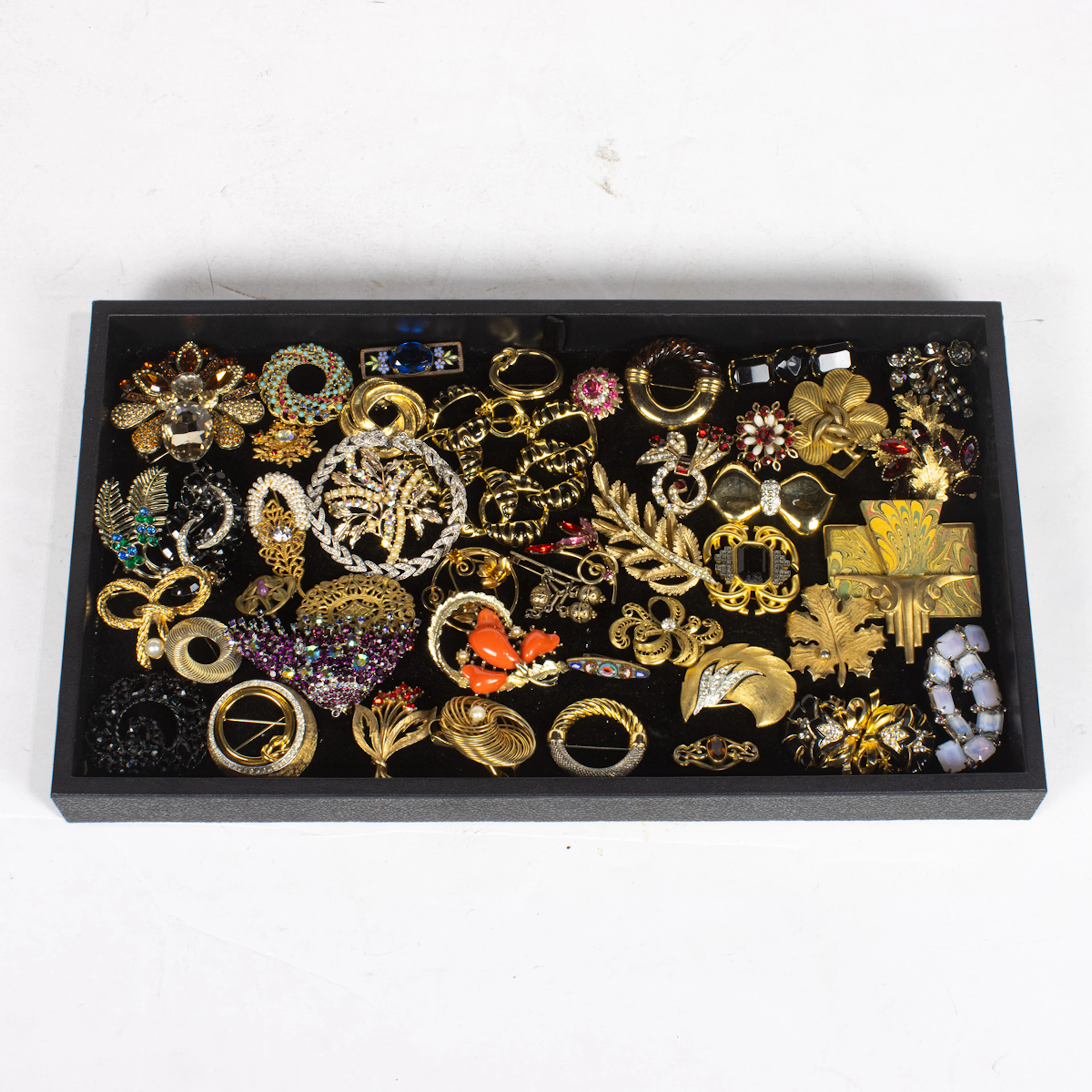 Forty-three costume jewelry brooches including Kirks Folly, Monet