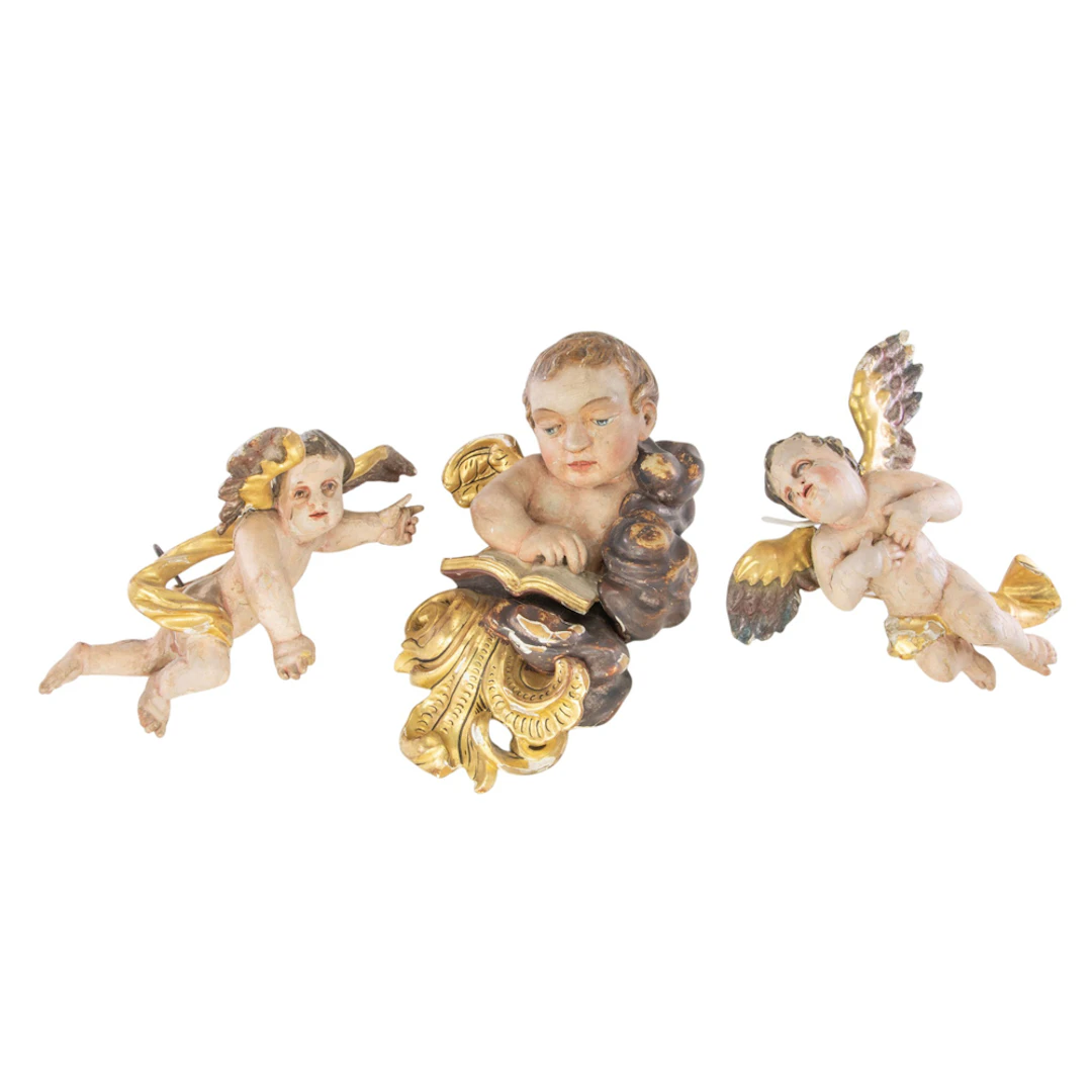 Three Continental polychrome and parcel gilt figures of putti