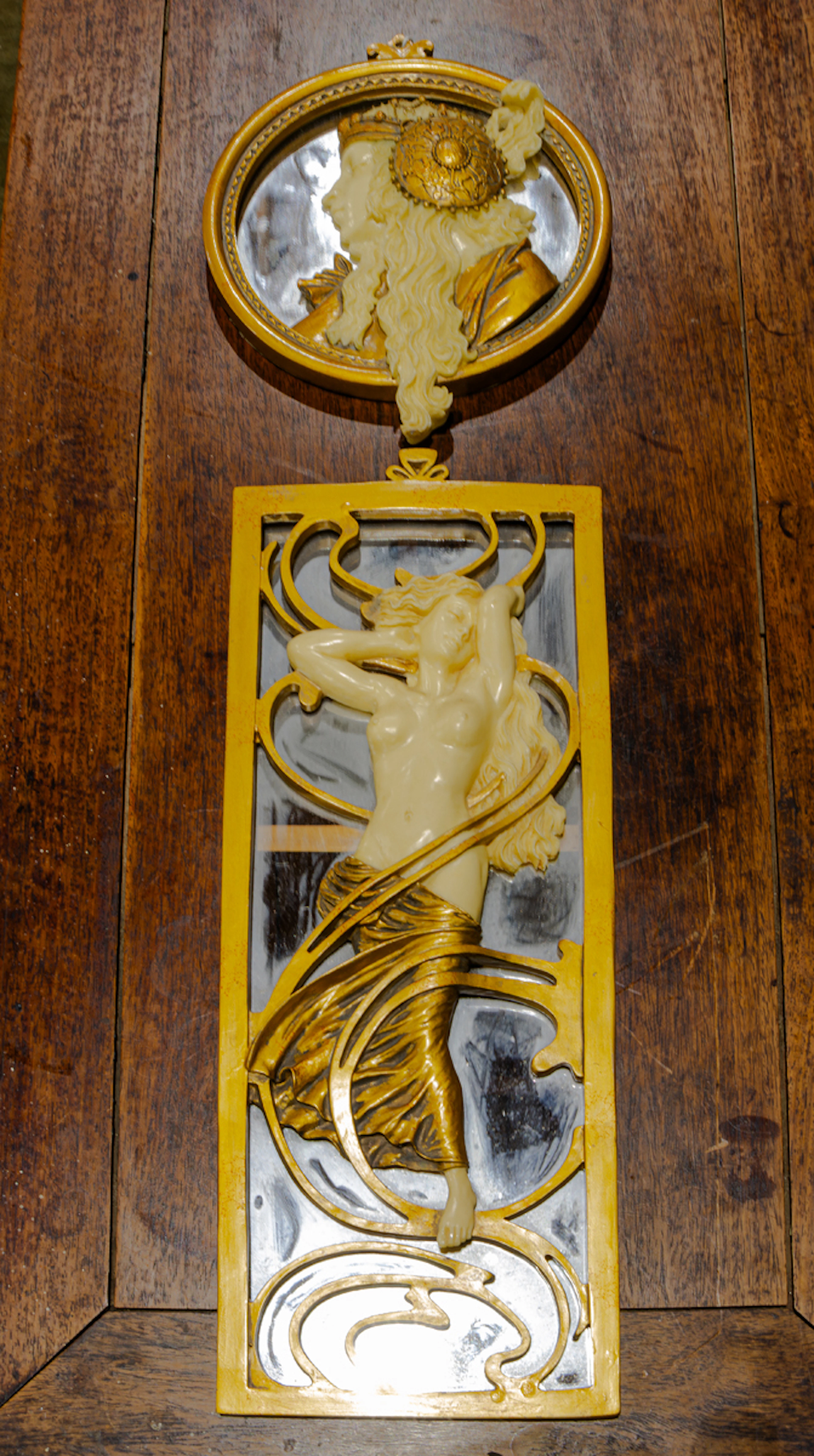 Two Art Nouveau style parcel gilt faux ivory figural wall mirrors