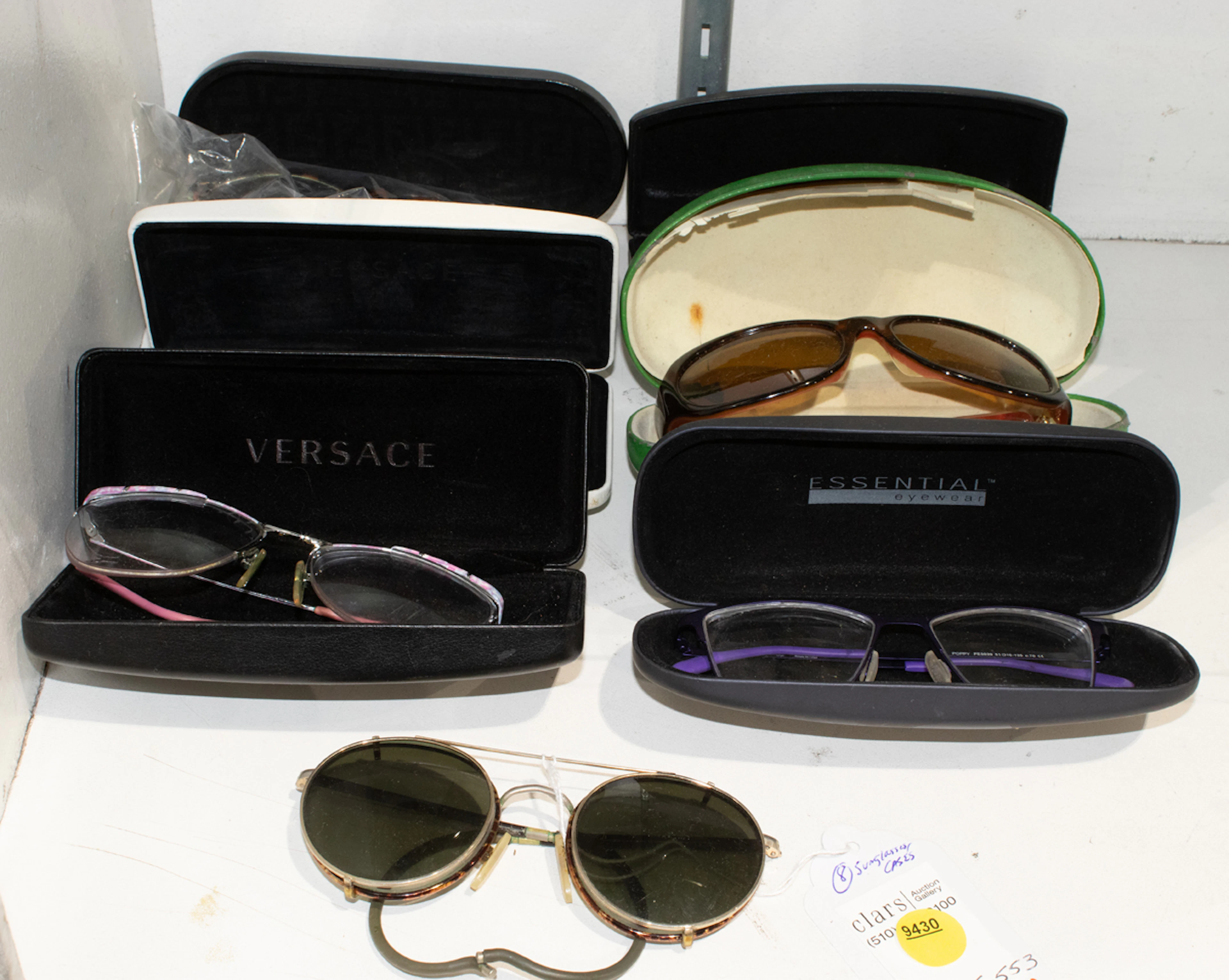 A group of vintage designer eyeglass frames, including Versace, Kate