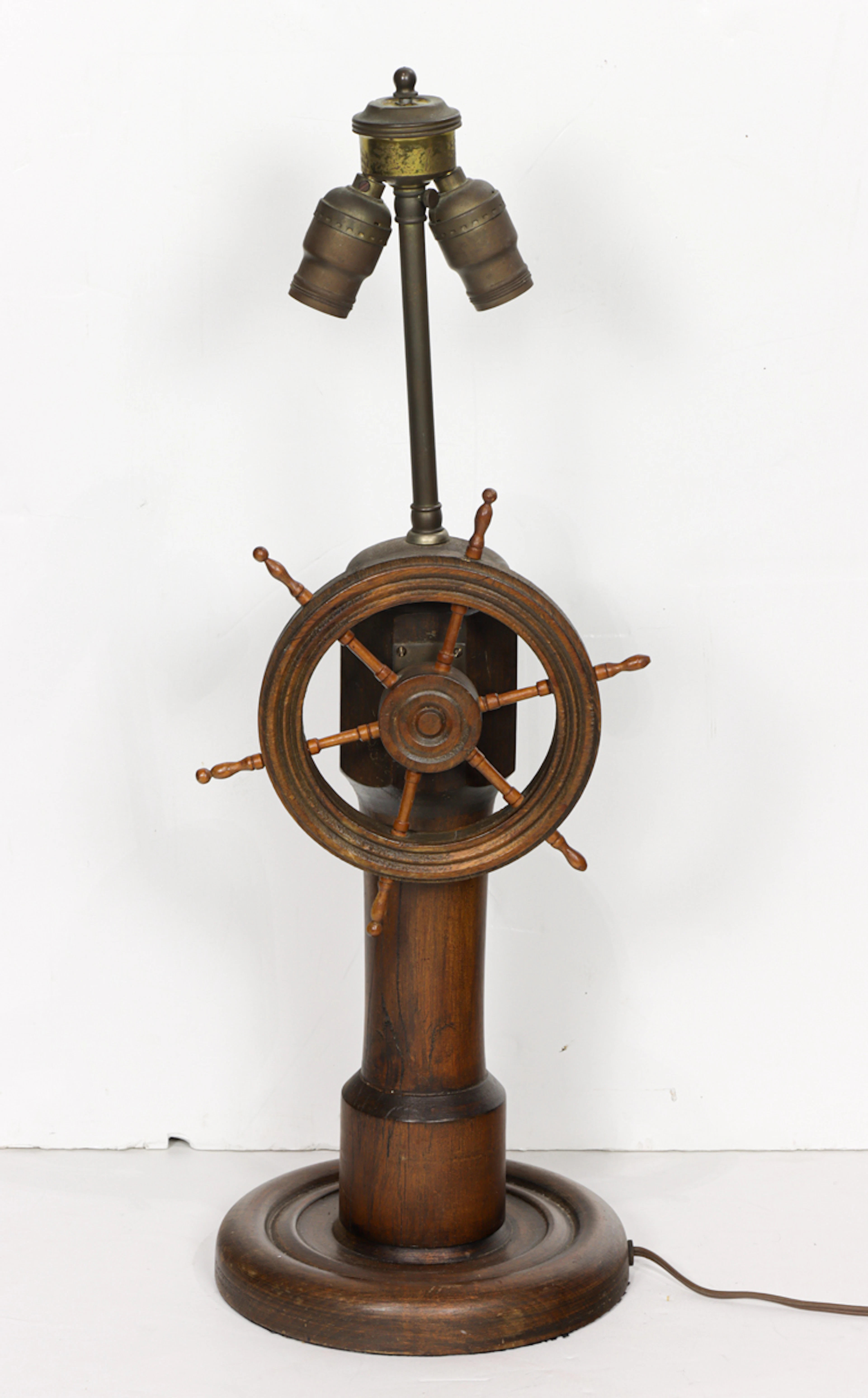 A vintage nautical wood lamp in the form of a ship's wheel