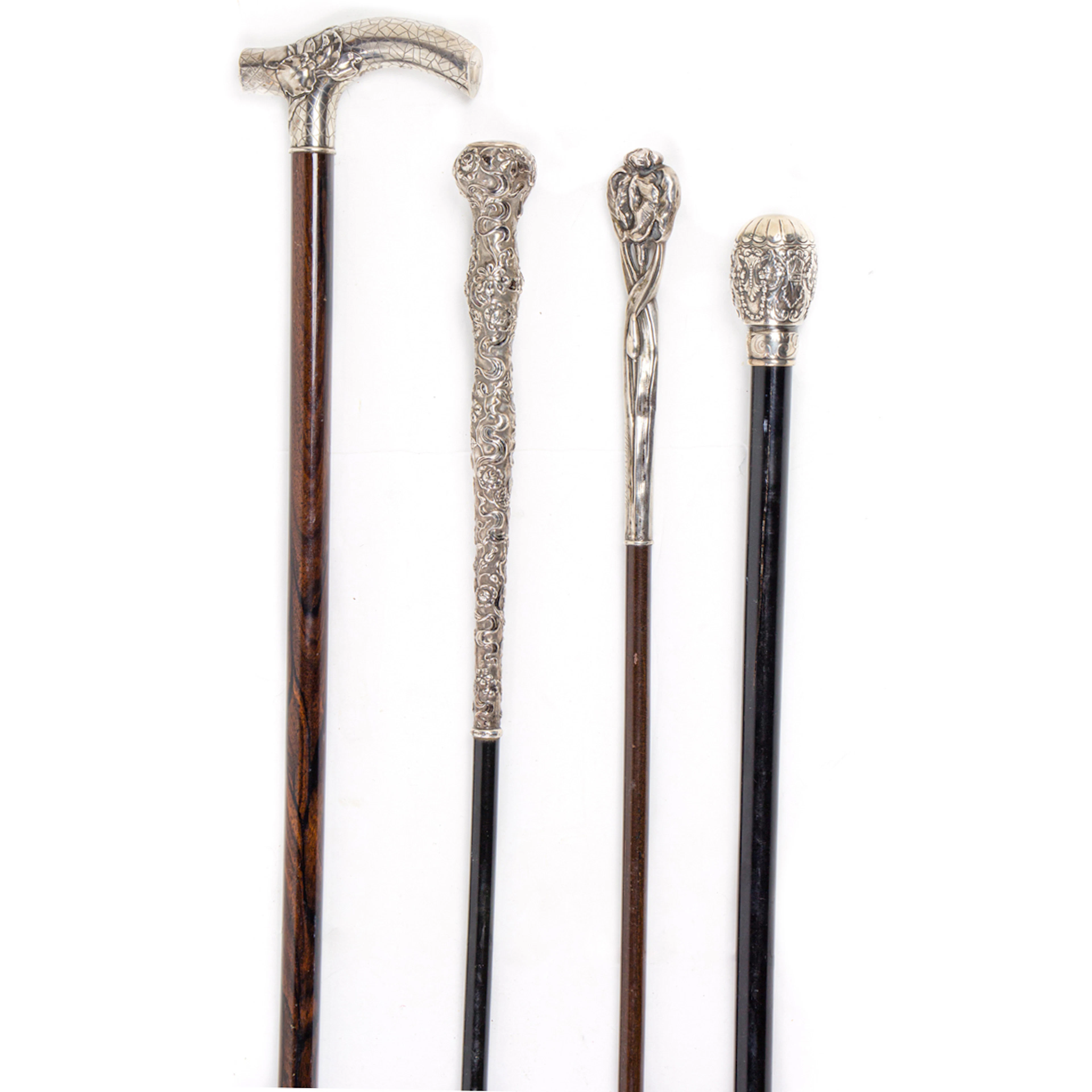 Four silver mounted walking canes or parasol handle