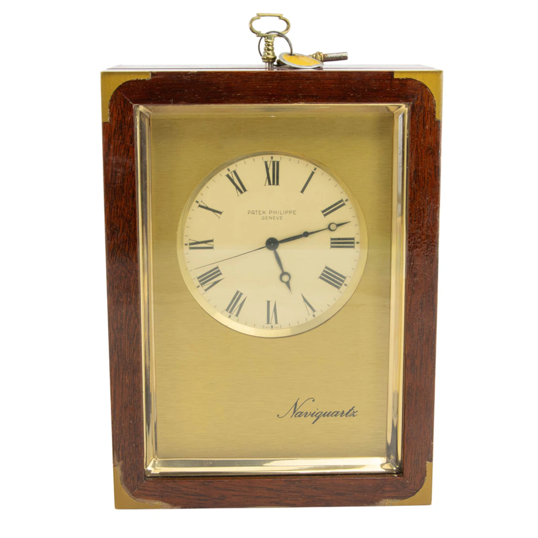 A Patek Philippe brass and mahogany Naviquartz table clock