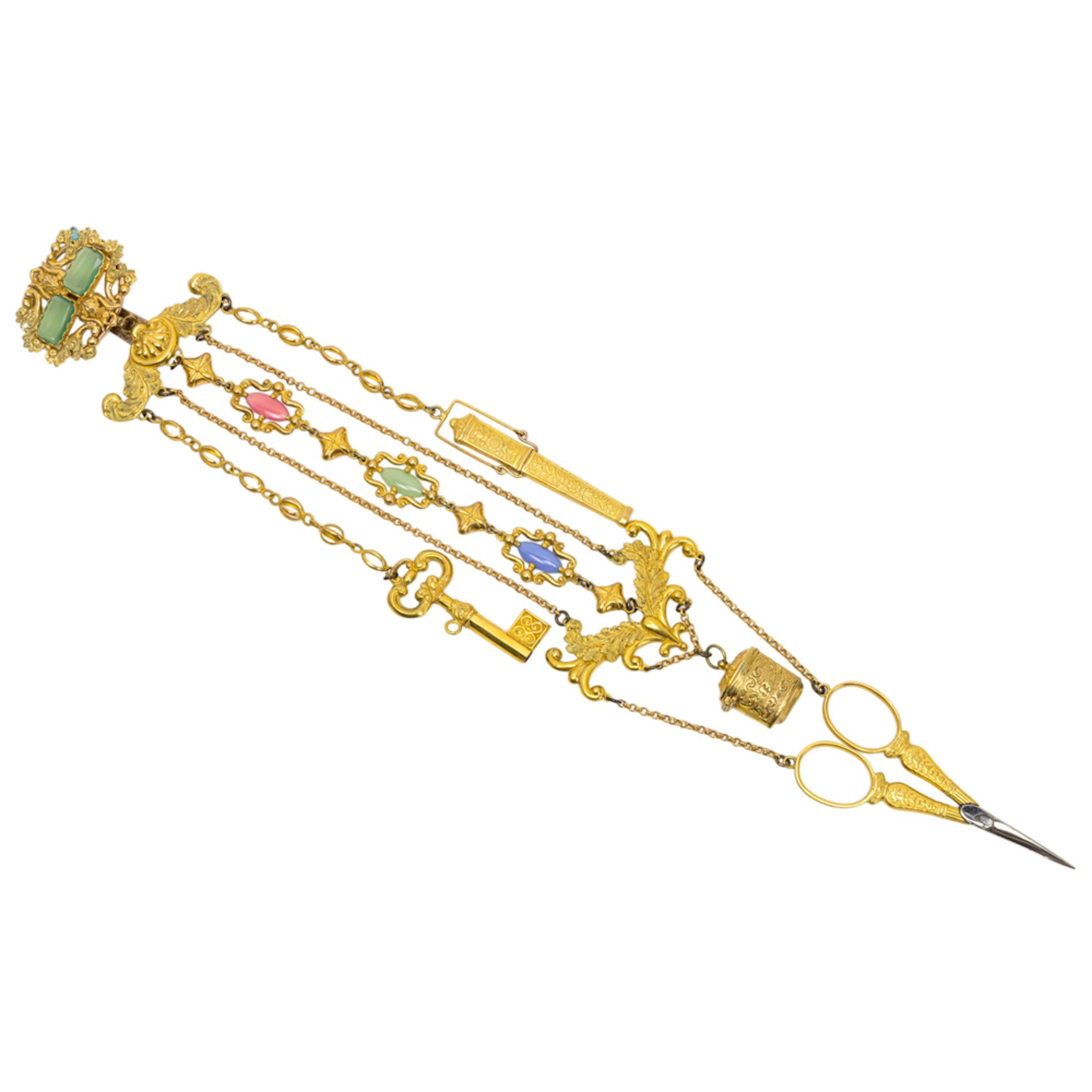 A French gilt metal chatelaine with glass cabochons