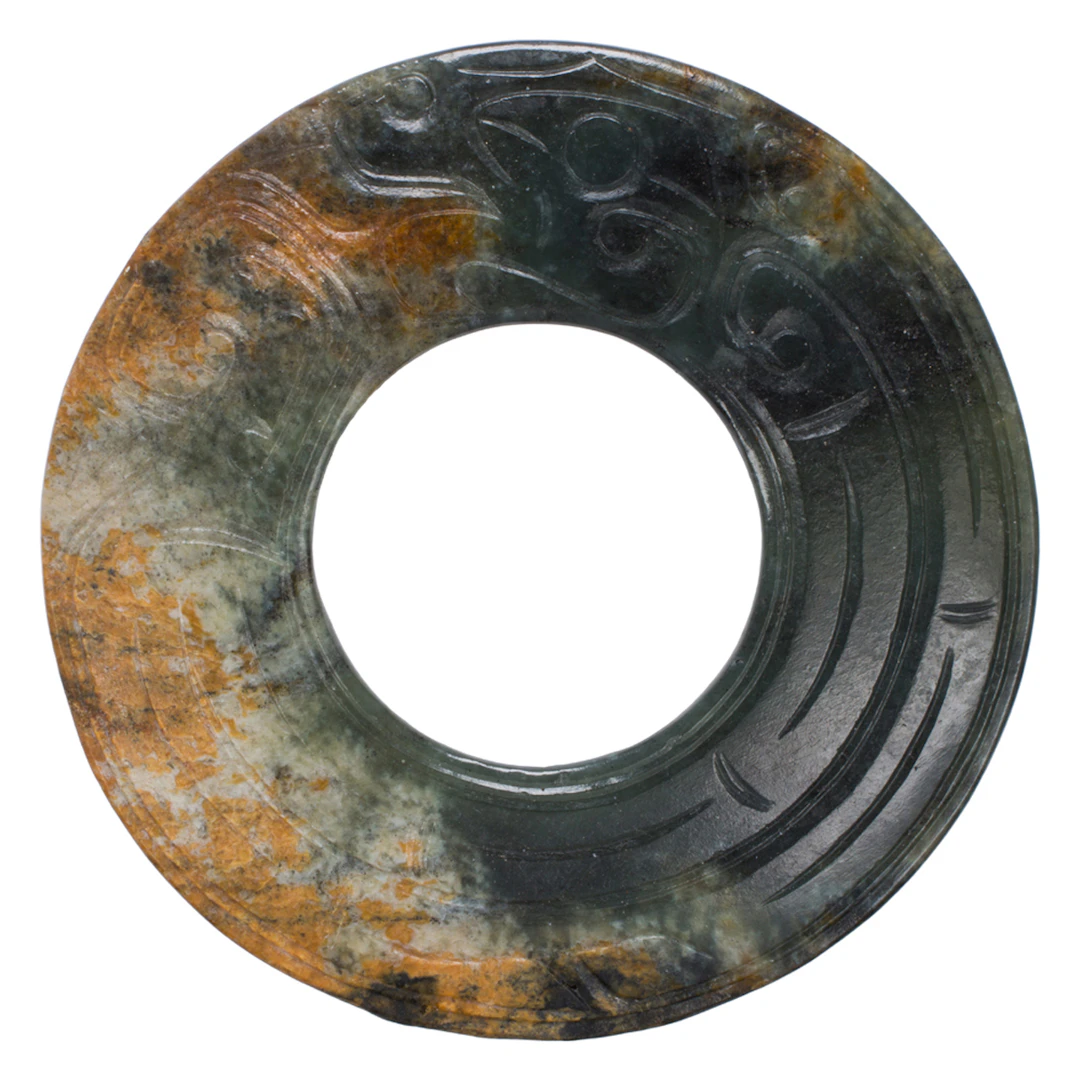 A Chinese mottled jade bi disc