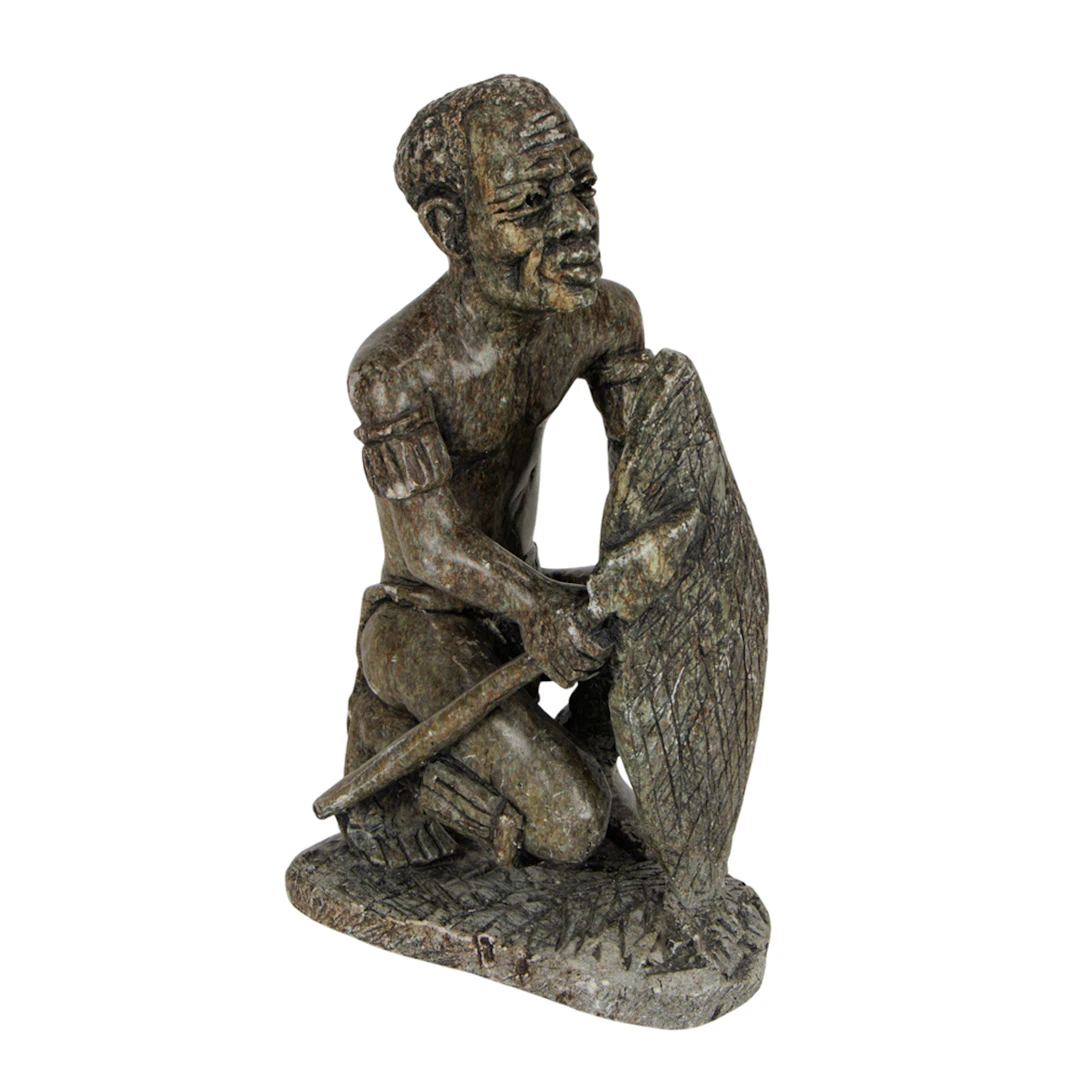 An African carved stone figure on a seated man