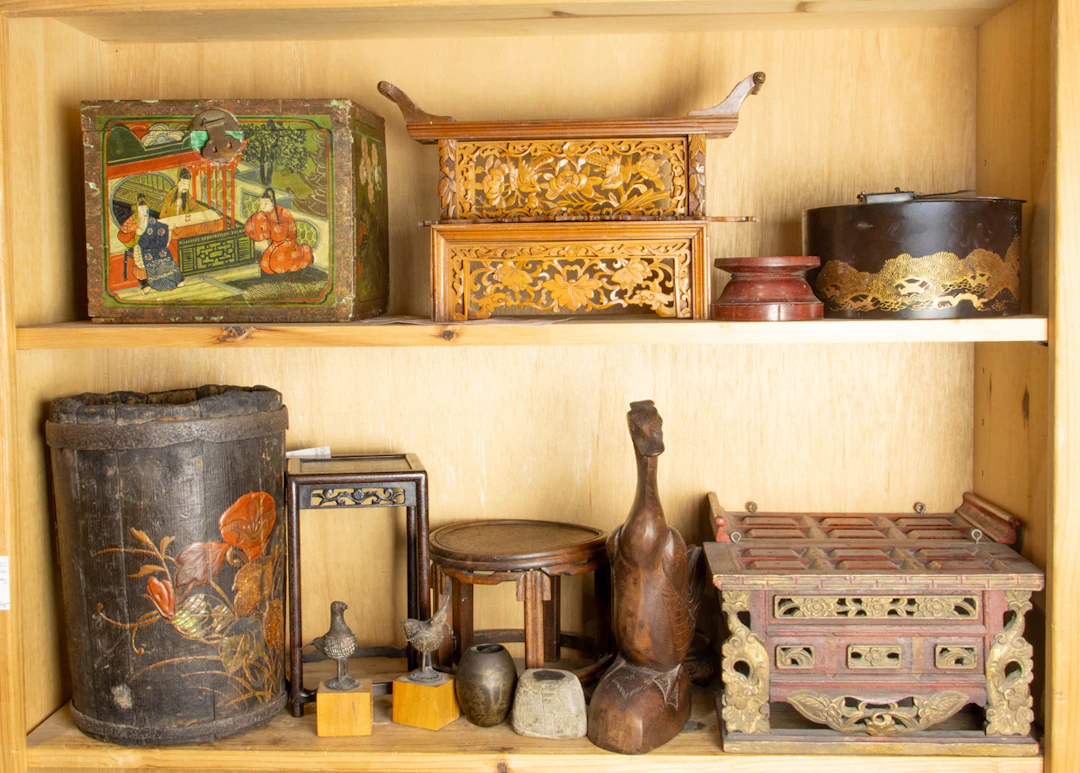 Two shelves of Asian decorative objects