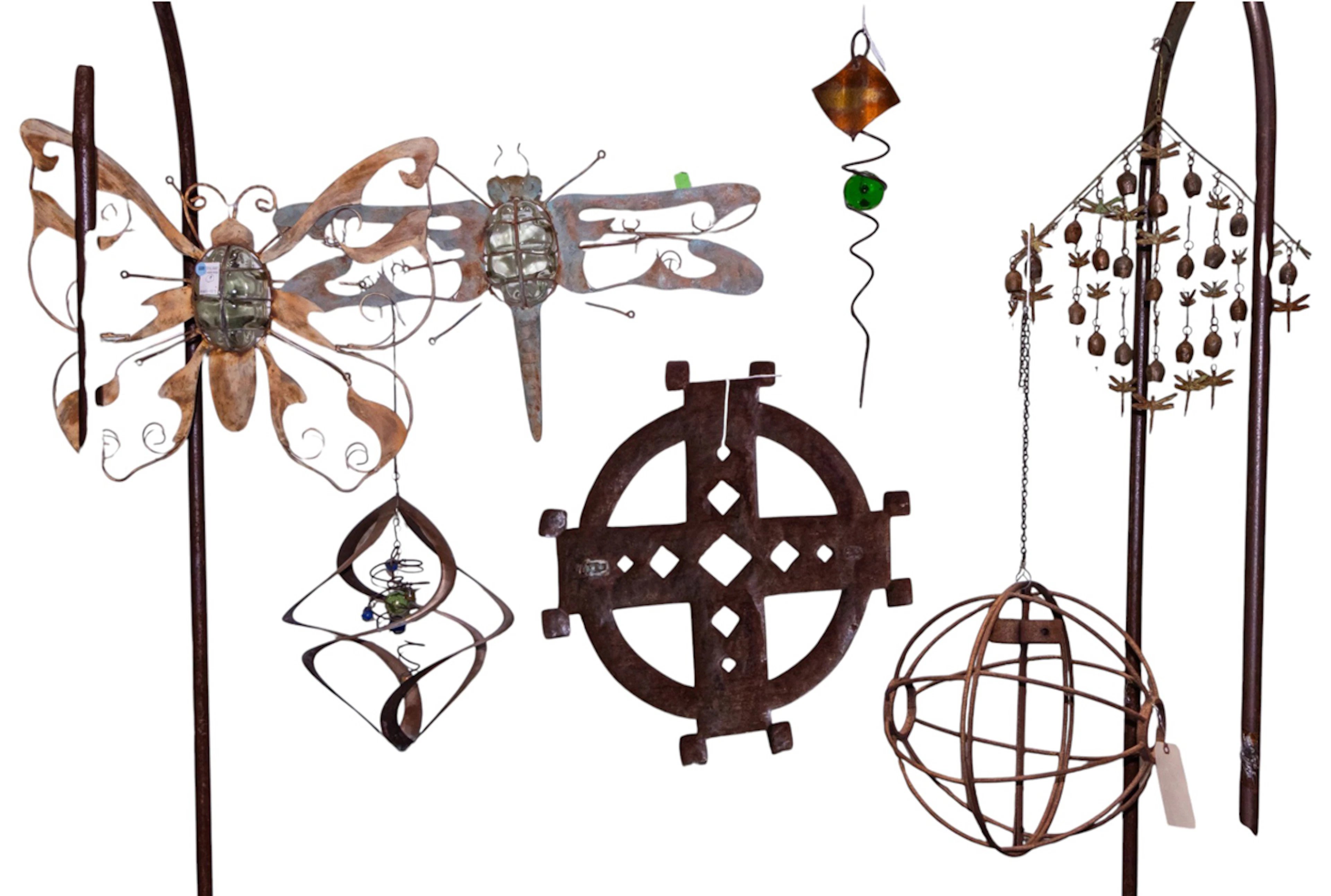 A group of metal outdoor hanging elements, together with a garden