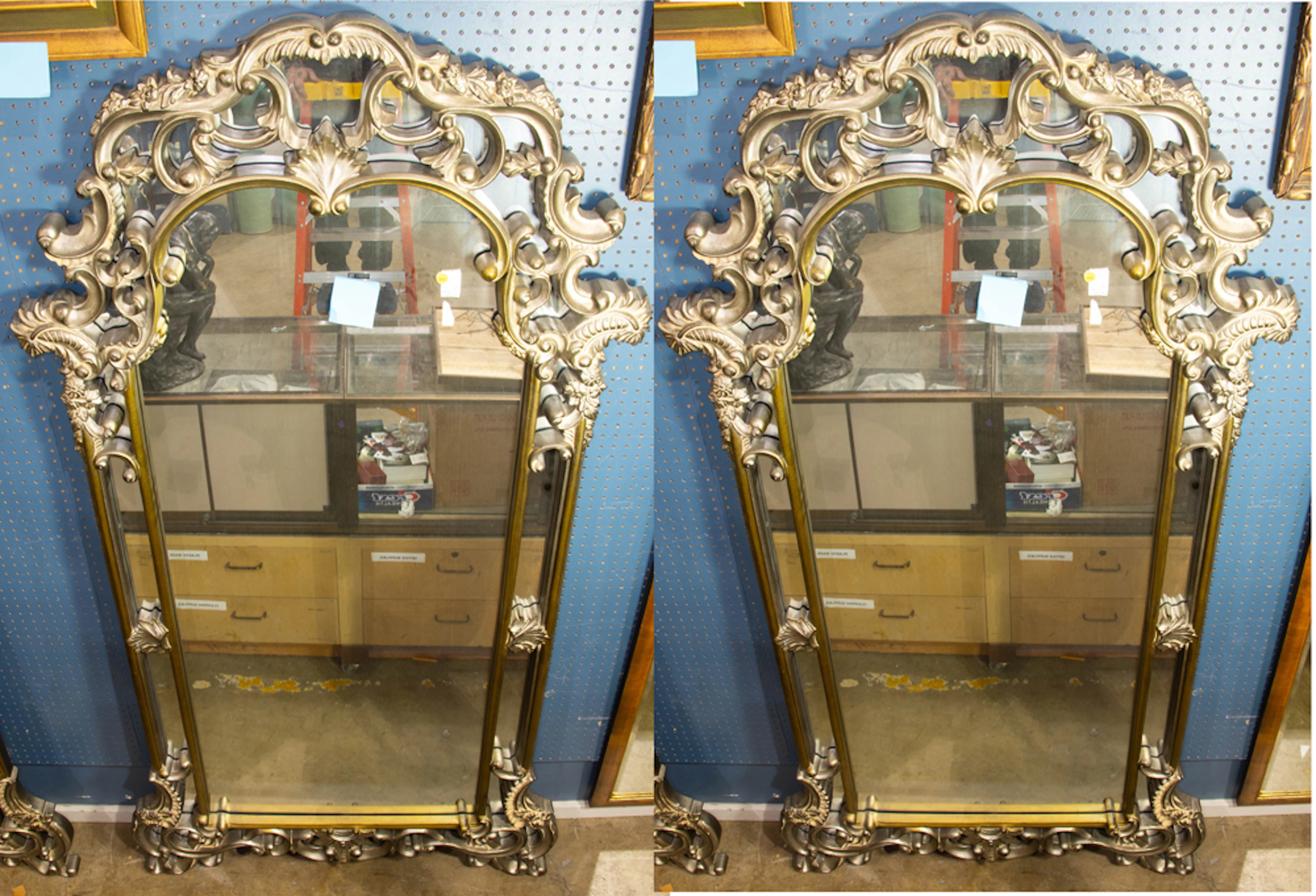 A massive pair of contemporary silvered composition mirrors in Baroque taste