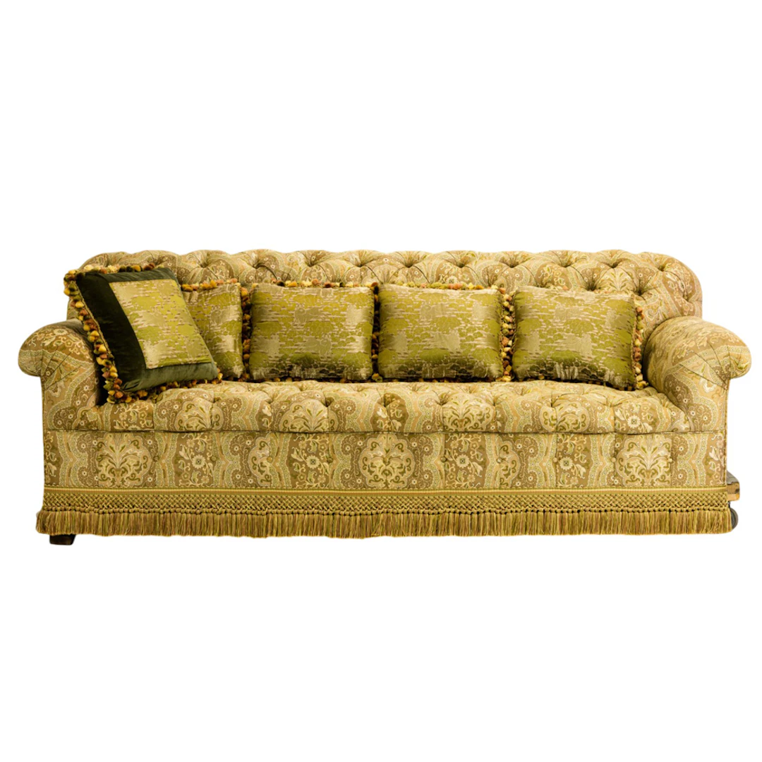 A large custom tufted upholstered sofa with five Japanese brocade throw pillows