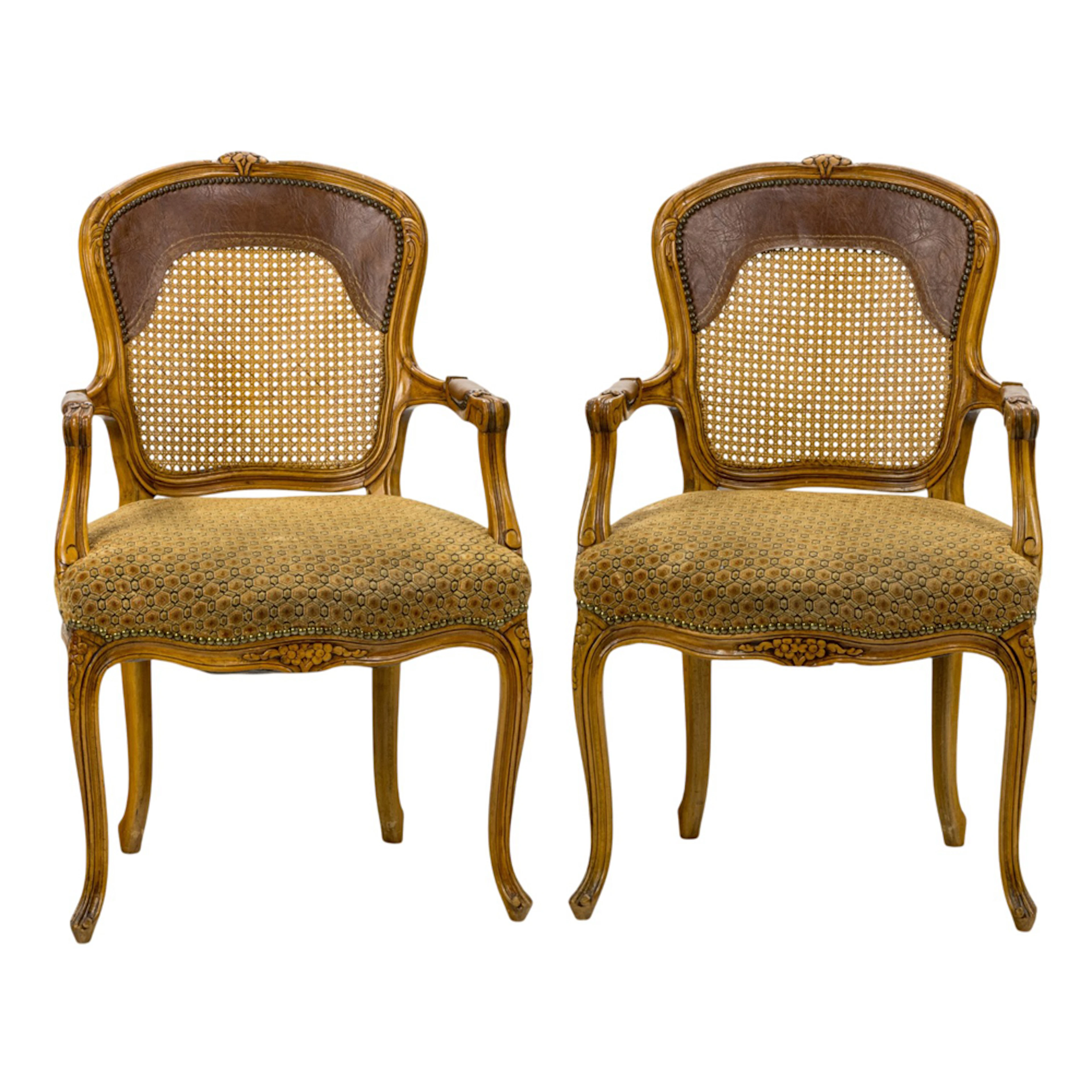 A pair of Louis XV style caned bergeres
