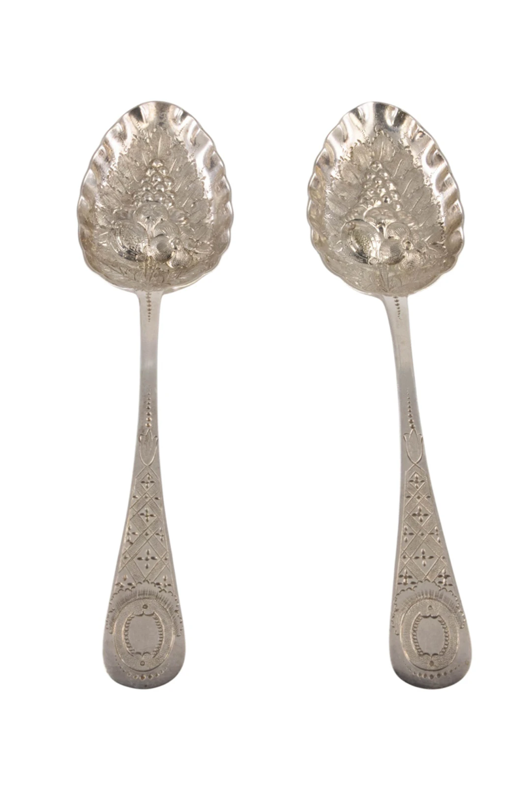 A Victorian plated pair of hand chased berry spoons