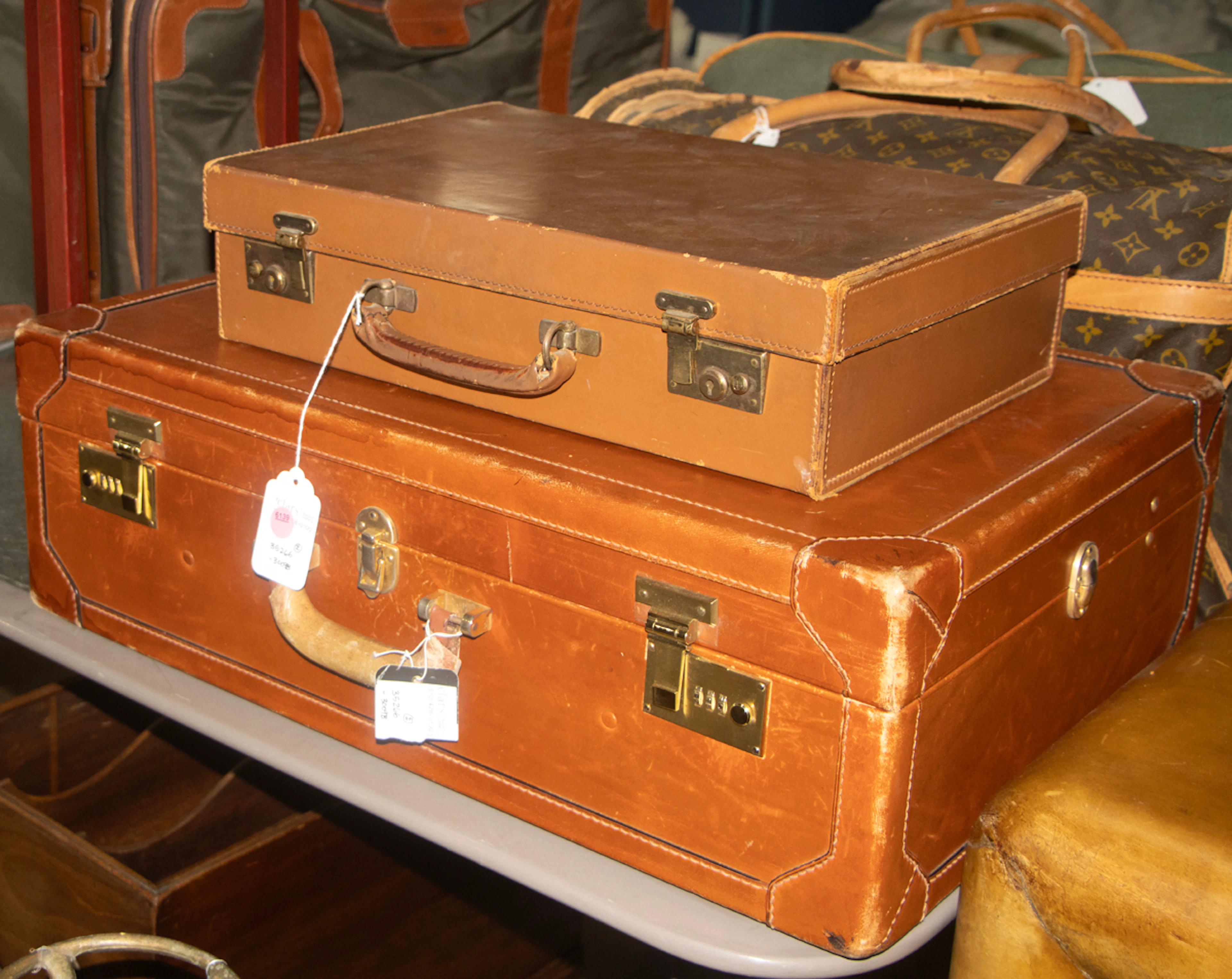 Three leather cases, including Brooks Brothers