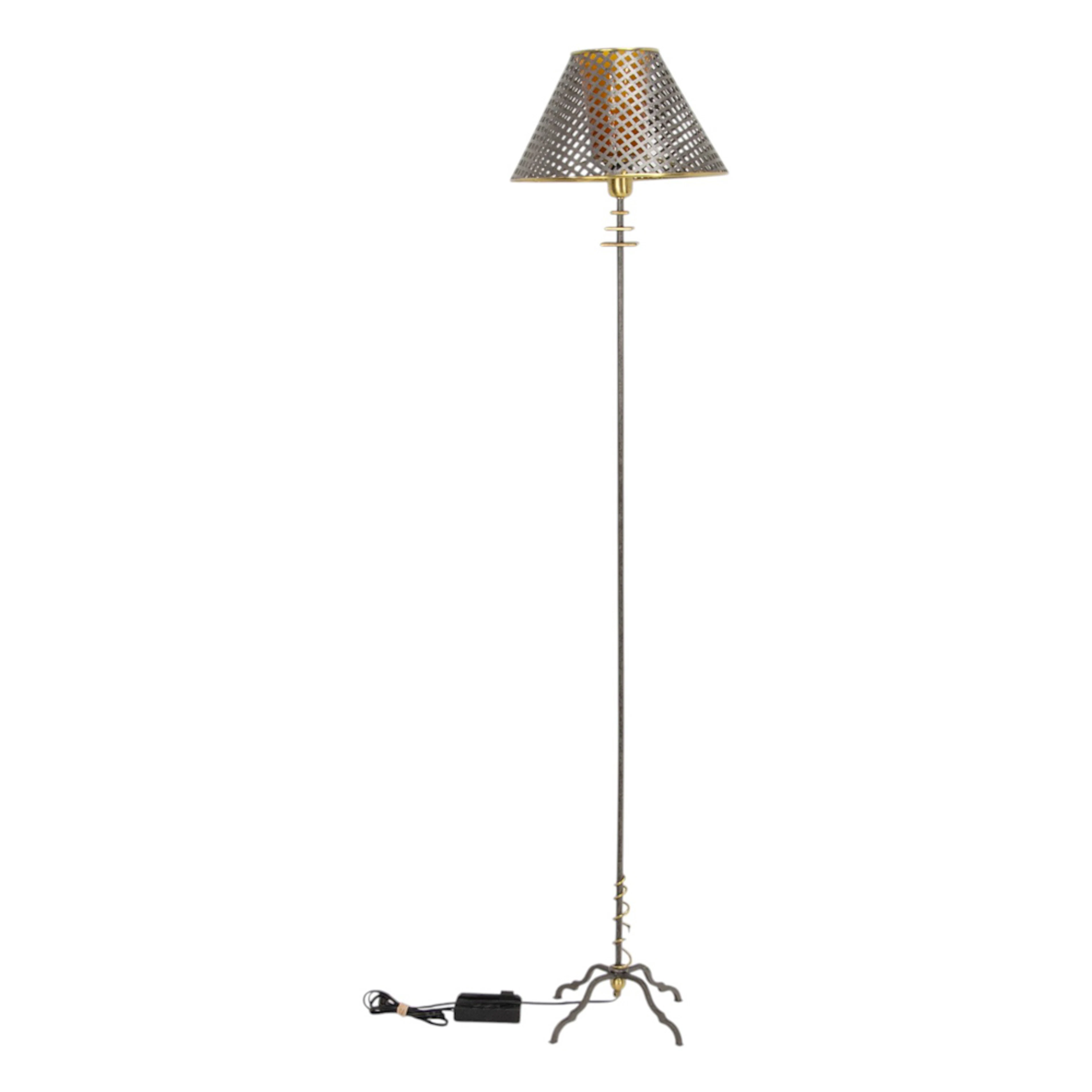 A contemporary mixed metal floor lamp