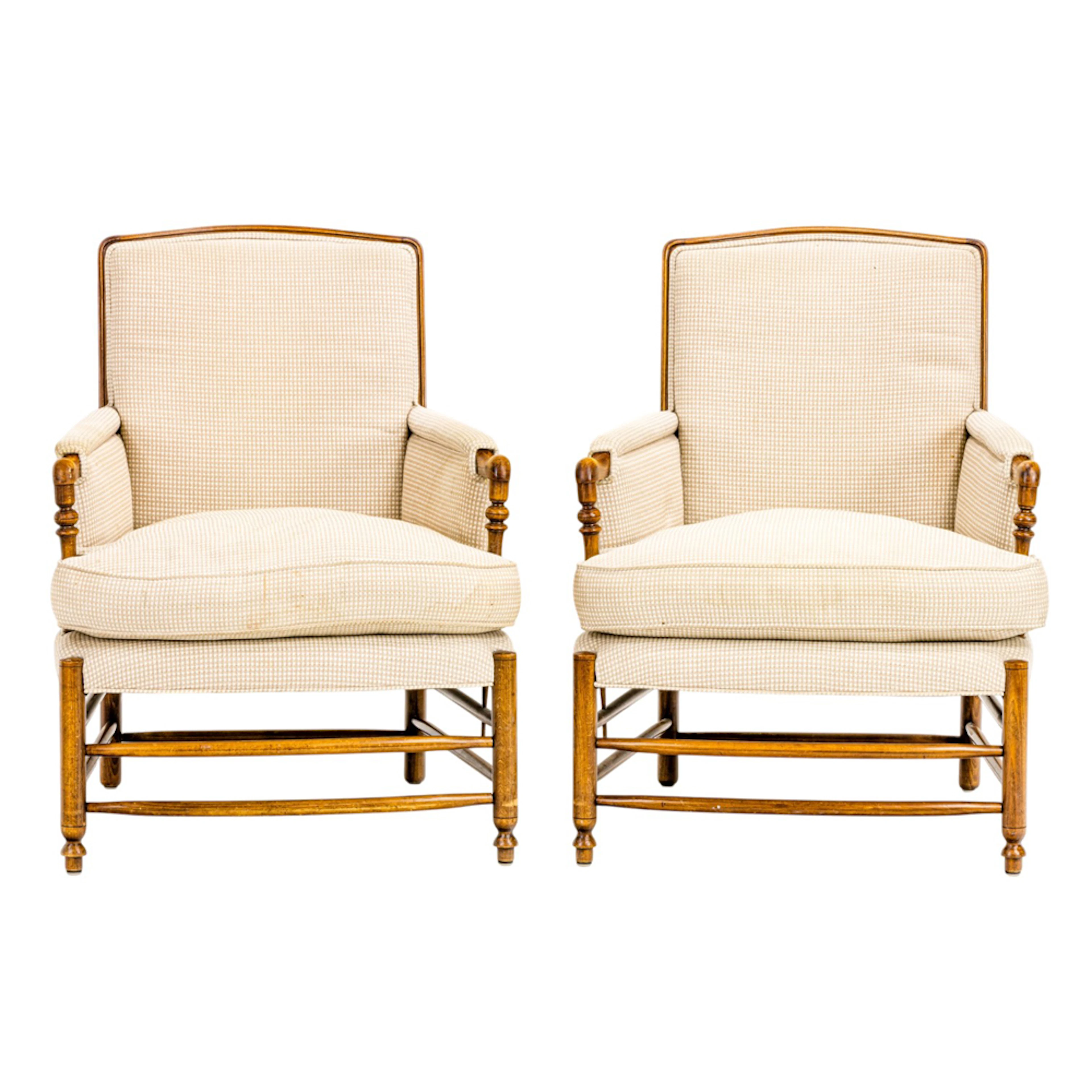 A pair of Provincial style upholstered armchairs