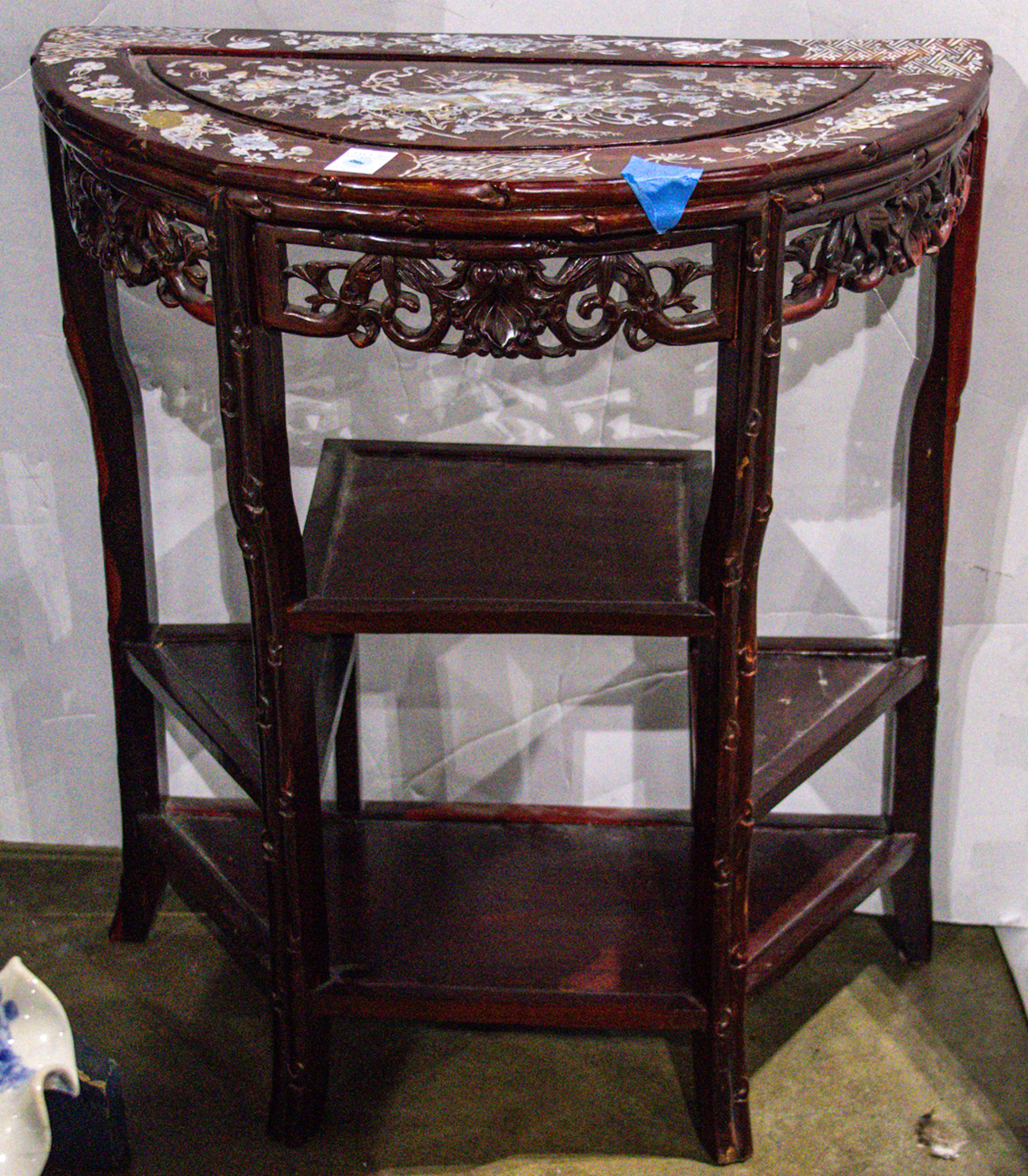 A Chinese hardwood demi-lune table with mother of pearl inlay
