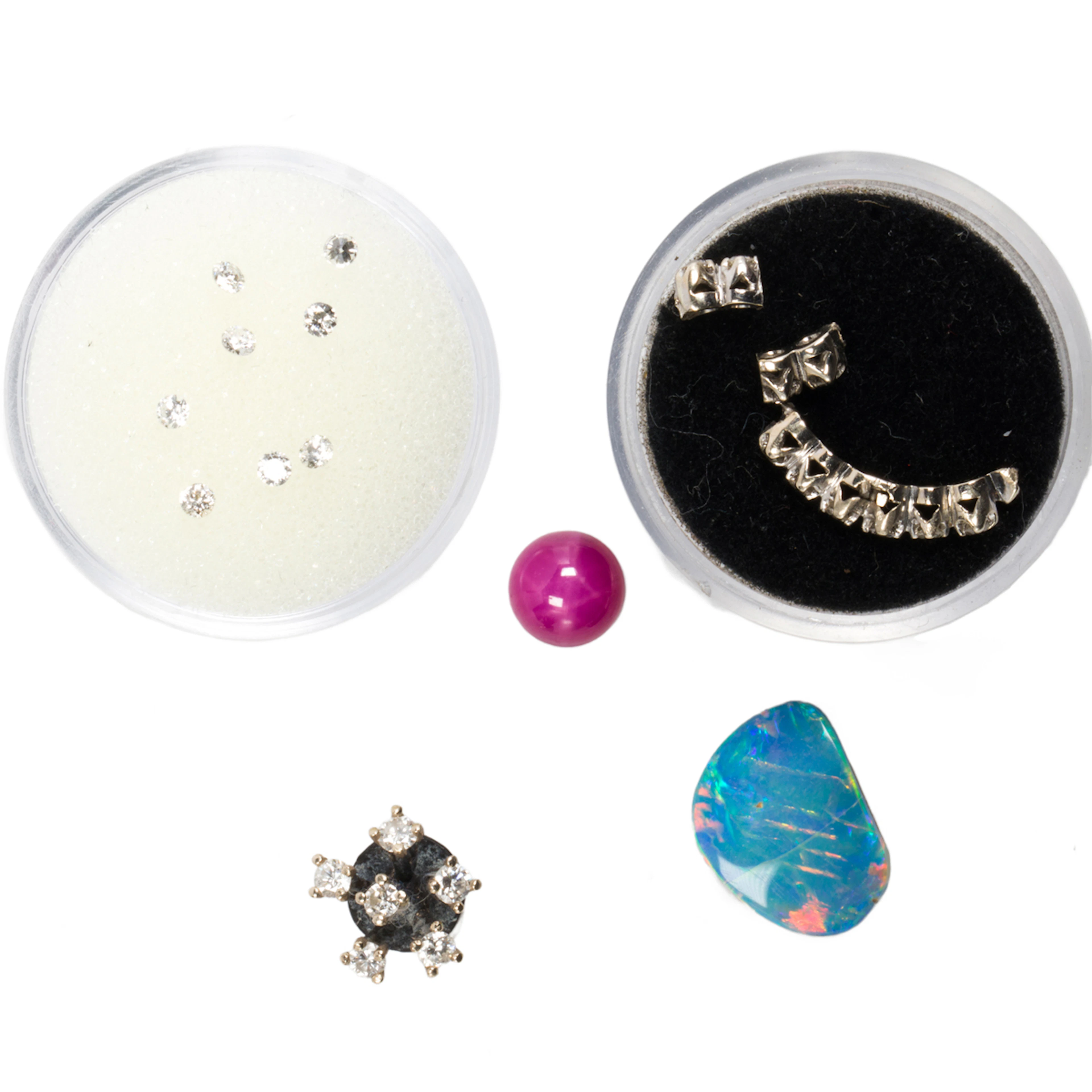 A group of unmounted gemstones and jewelry findings