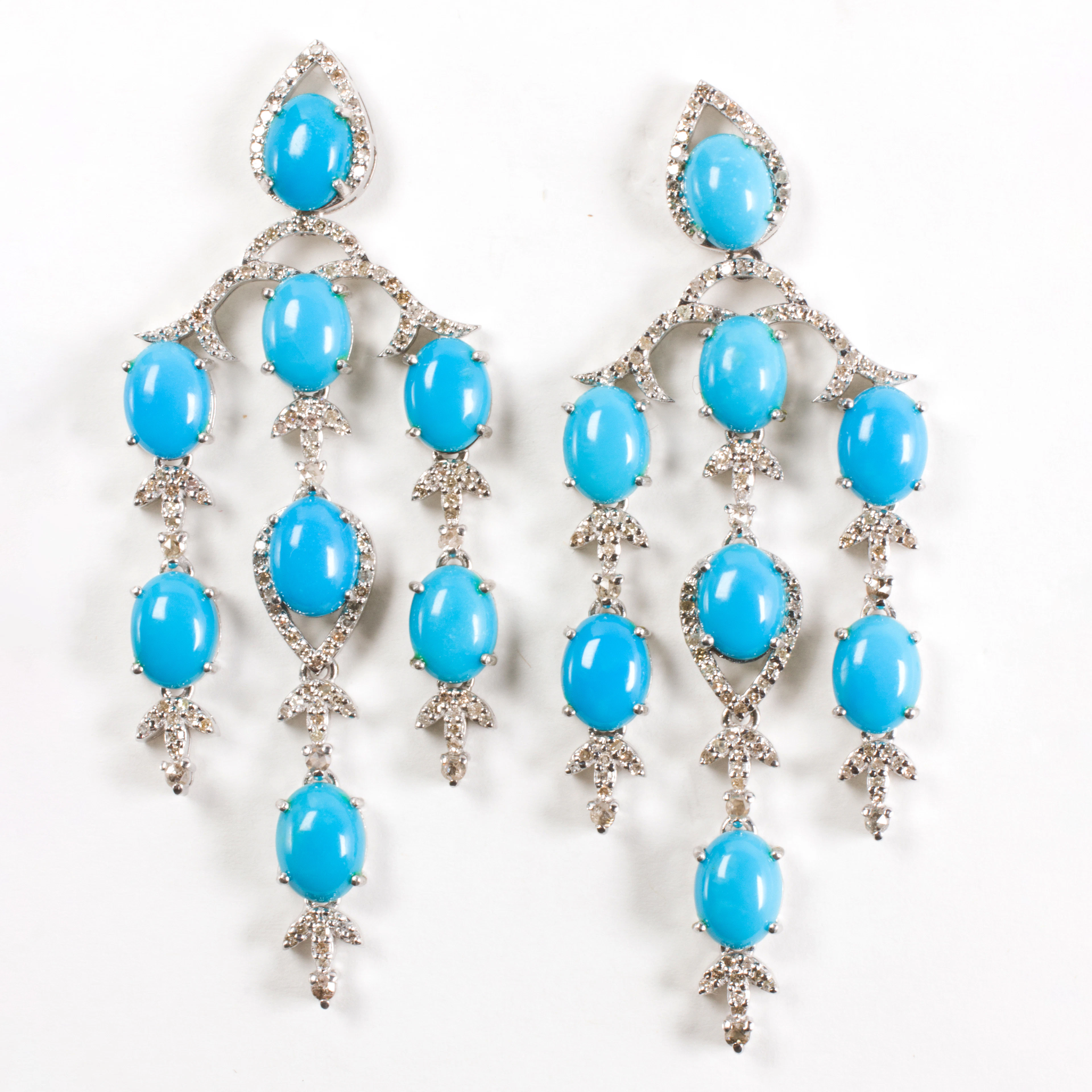 A pair of turquoise, diamond, and sterling silver earrings