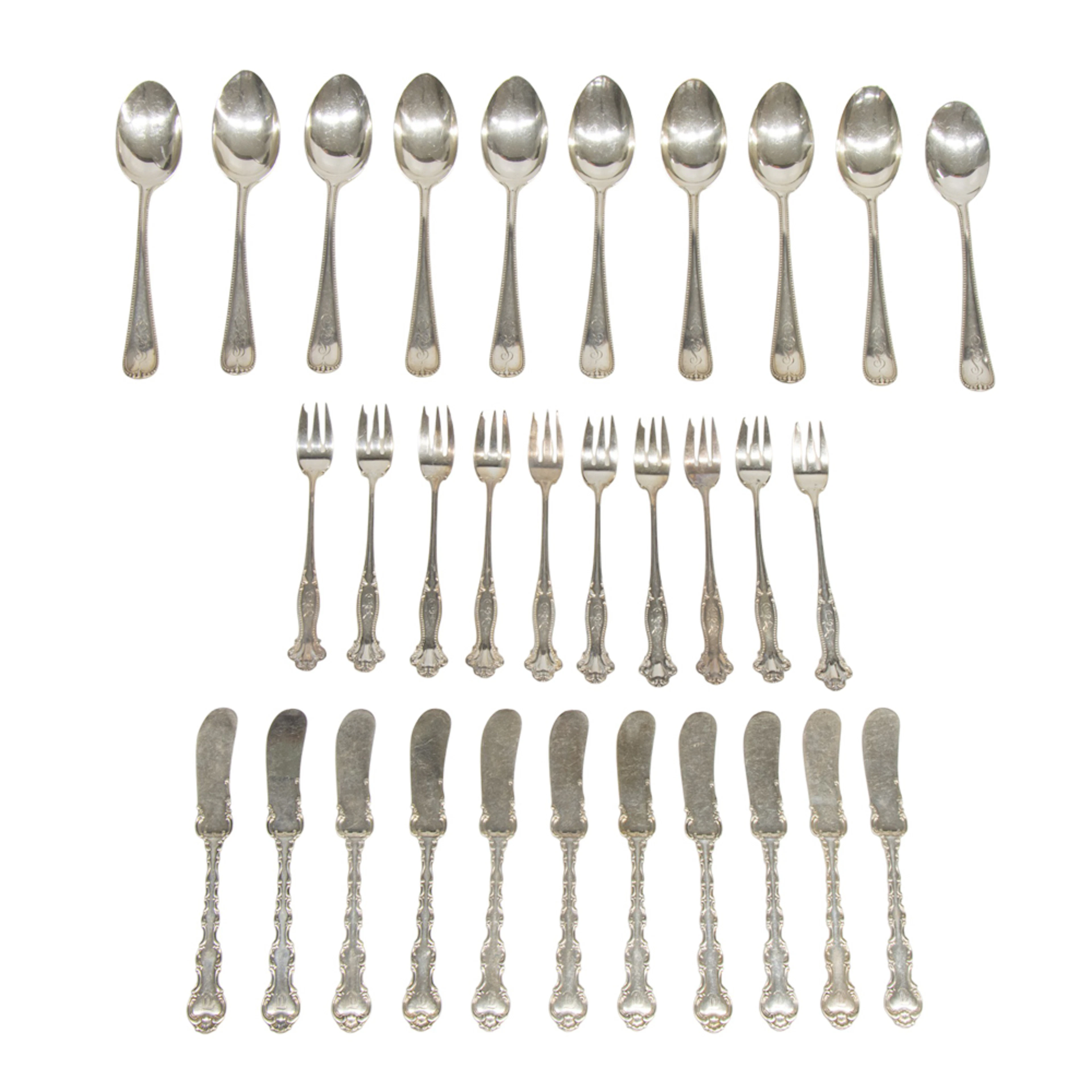 A group of sterling flatware