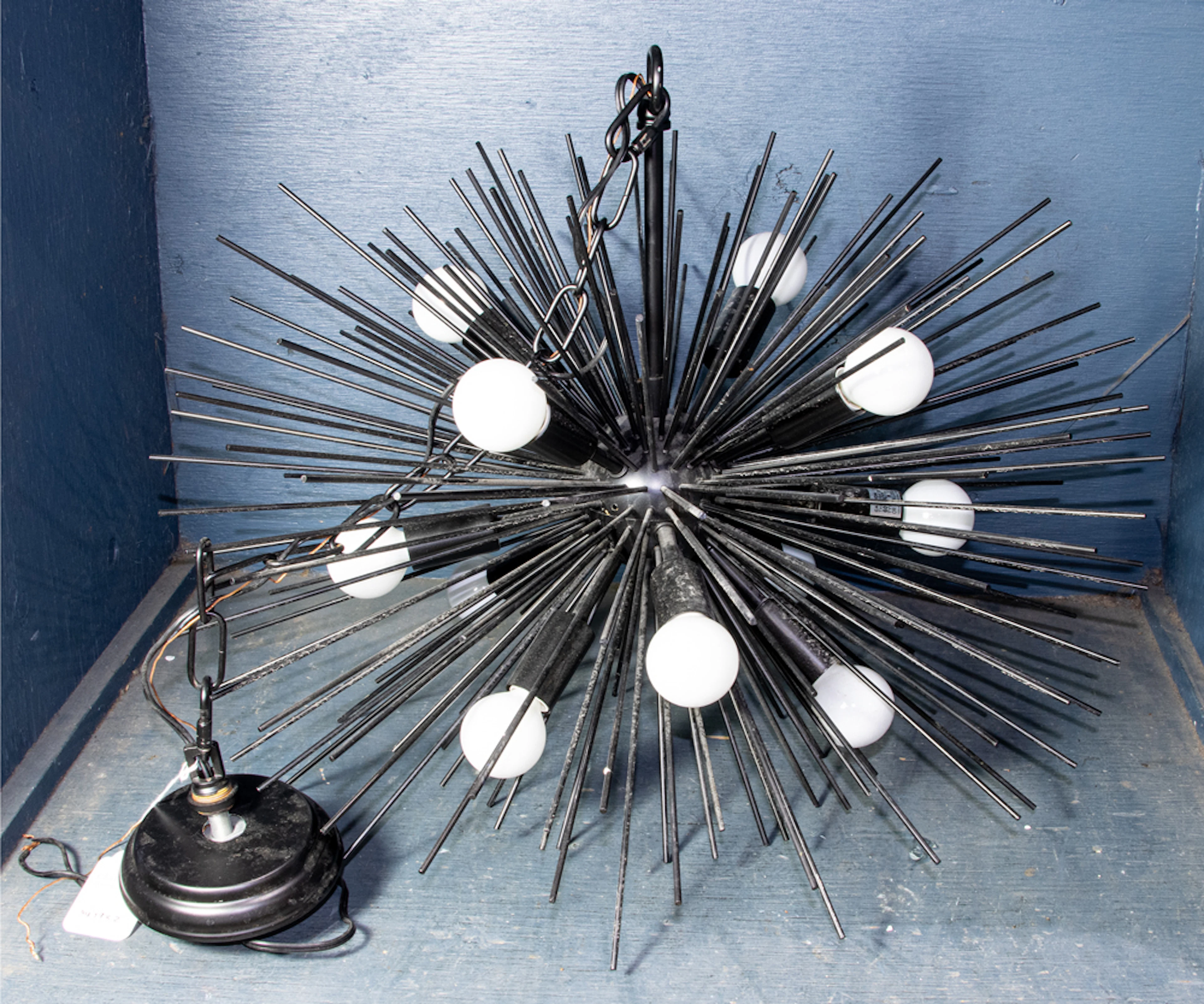 A contemporary urchin style semi-flush mount chandelier