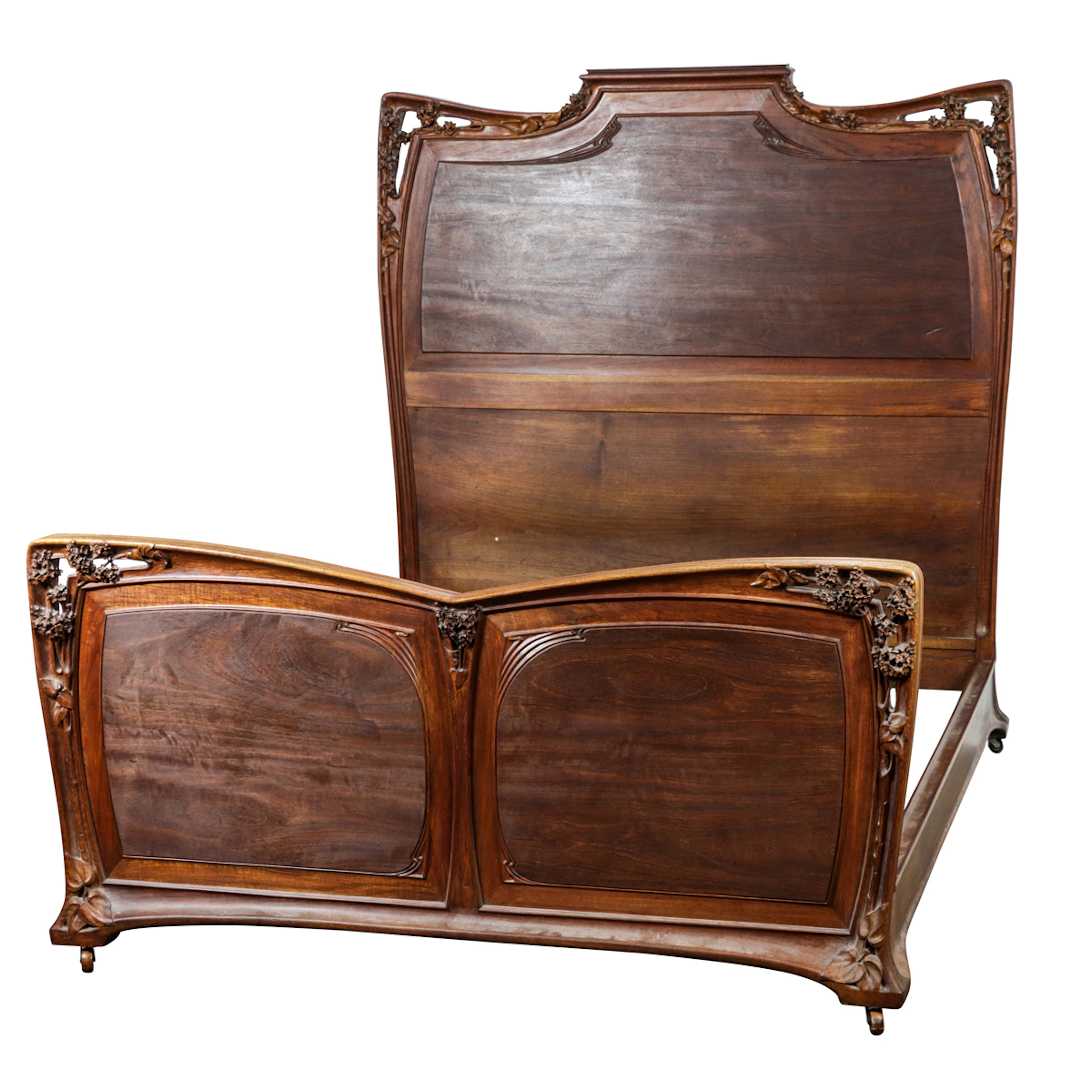 A Louis Majorelle floral carved high back bed circa 1900