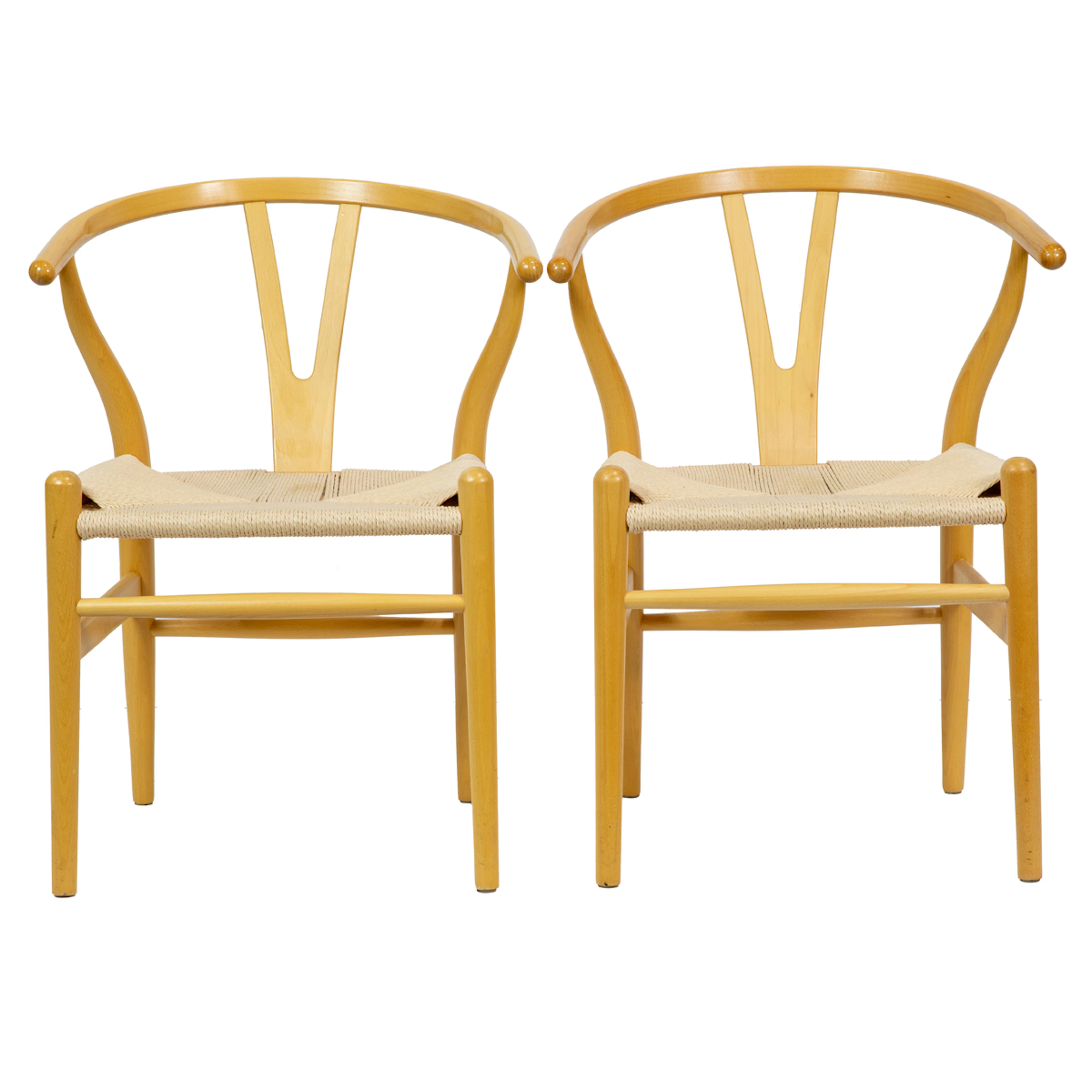 A pair of wishbone style arm chairs
