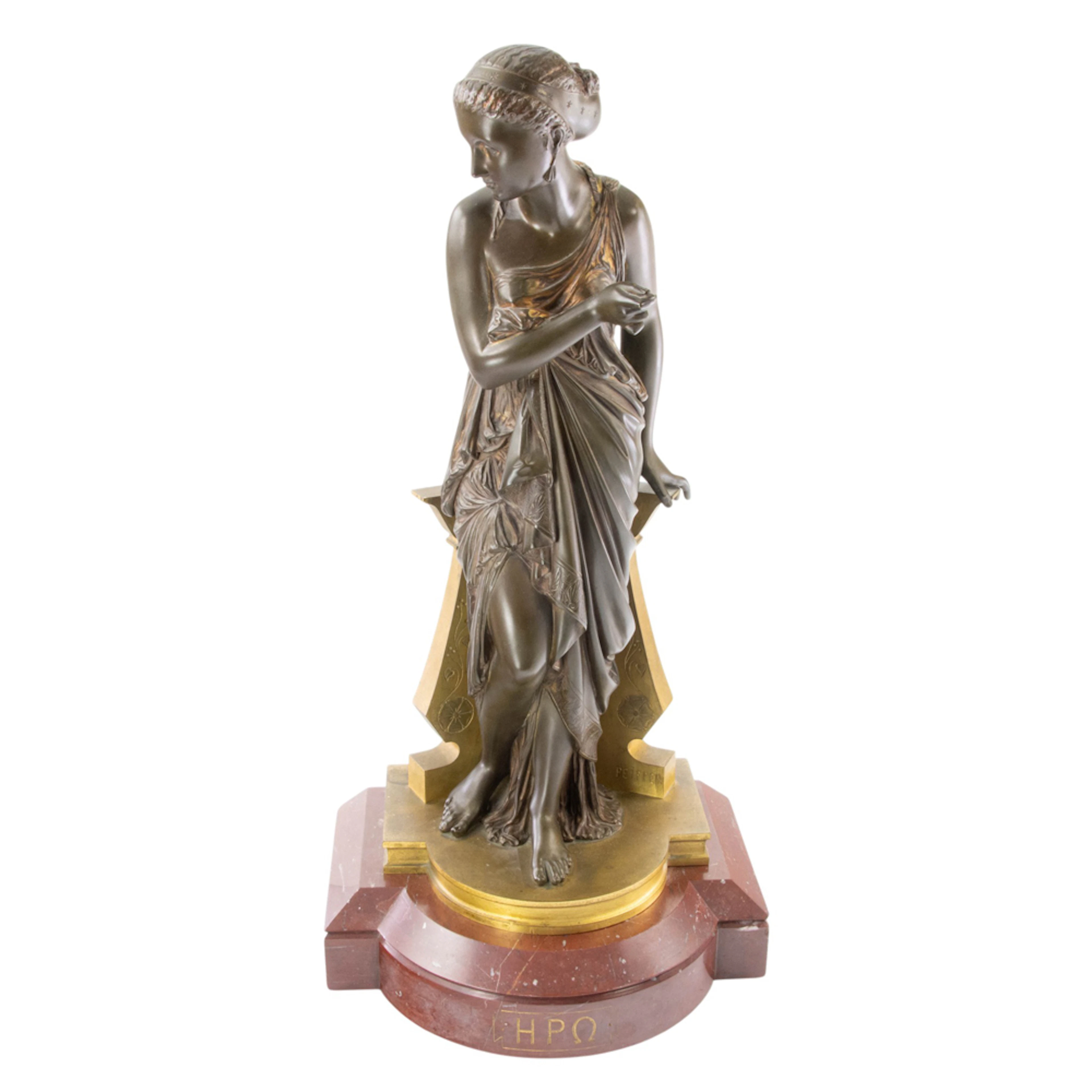 A French patinated and gilt bronze figure of a Grecian muse: Erato