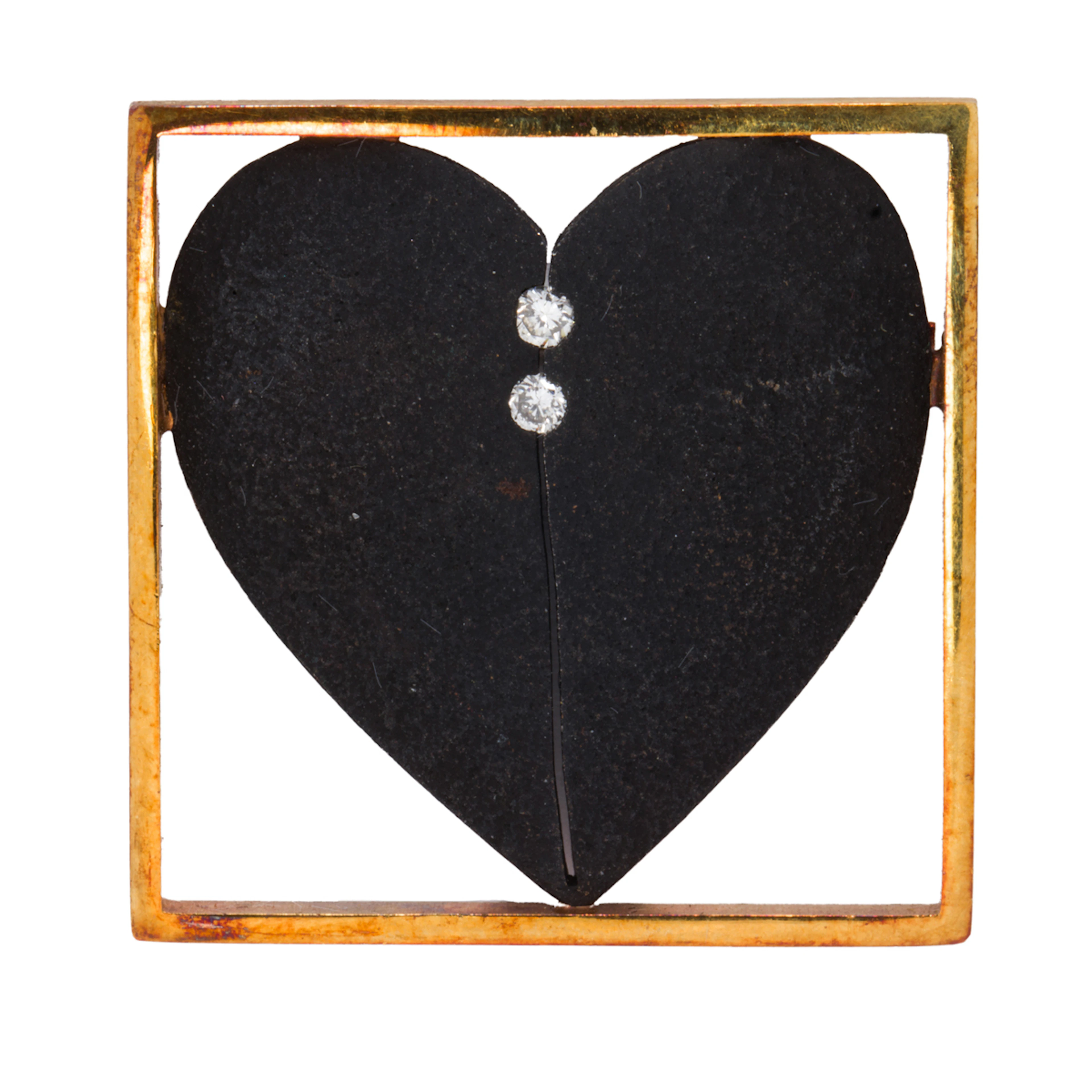 A diamond, metal, and 18k gold brooch