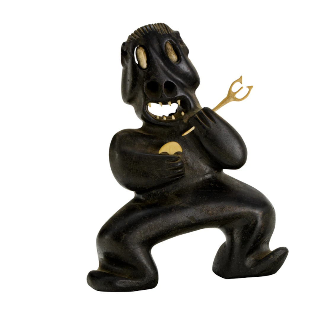 An Inuit carved stone and bone figure