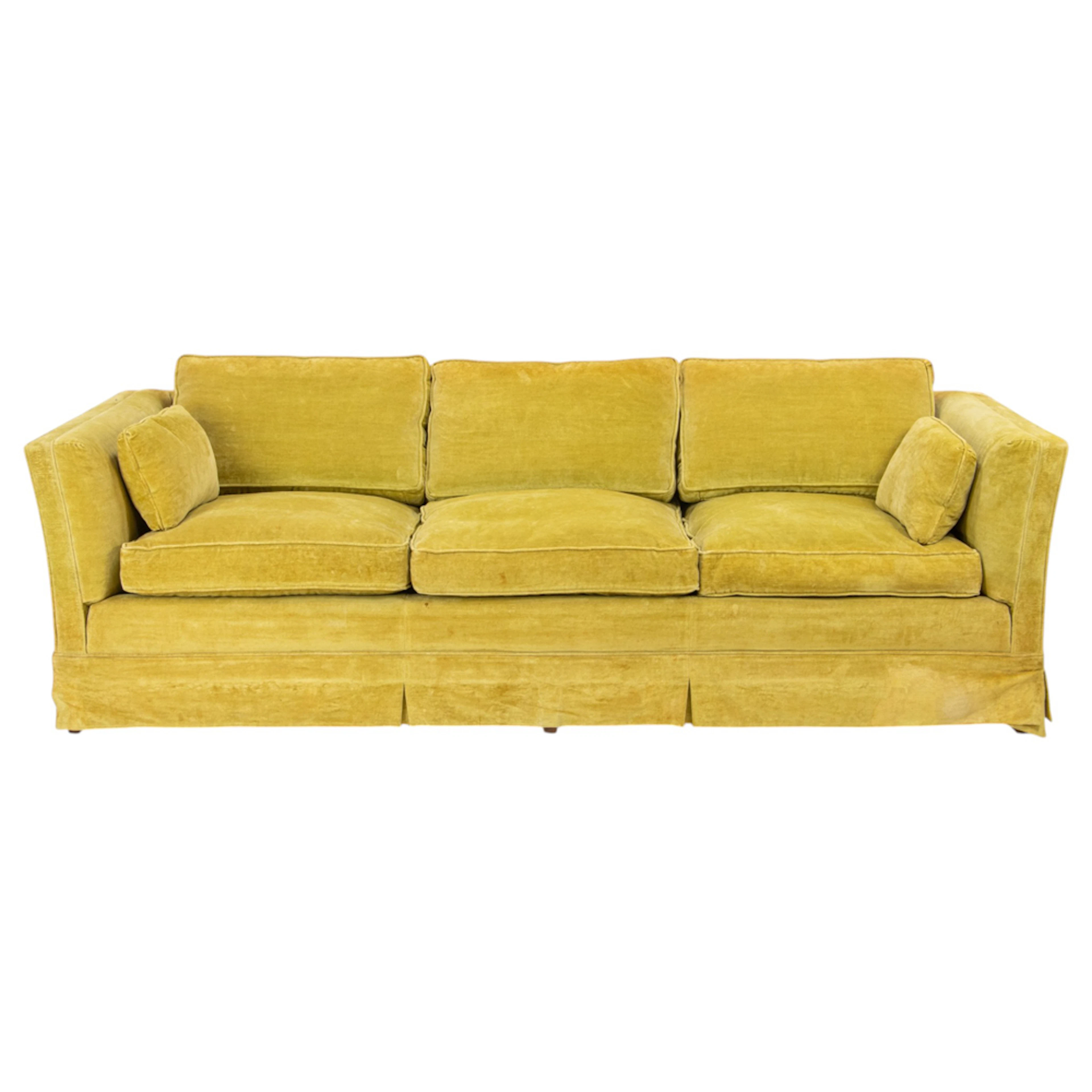 A vintage chartreuse velour upholstered three-seat tuxedo sofa