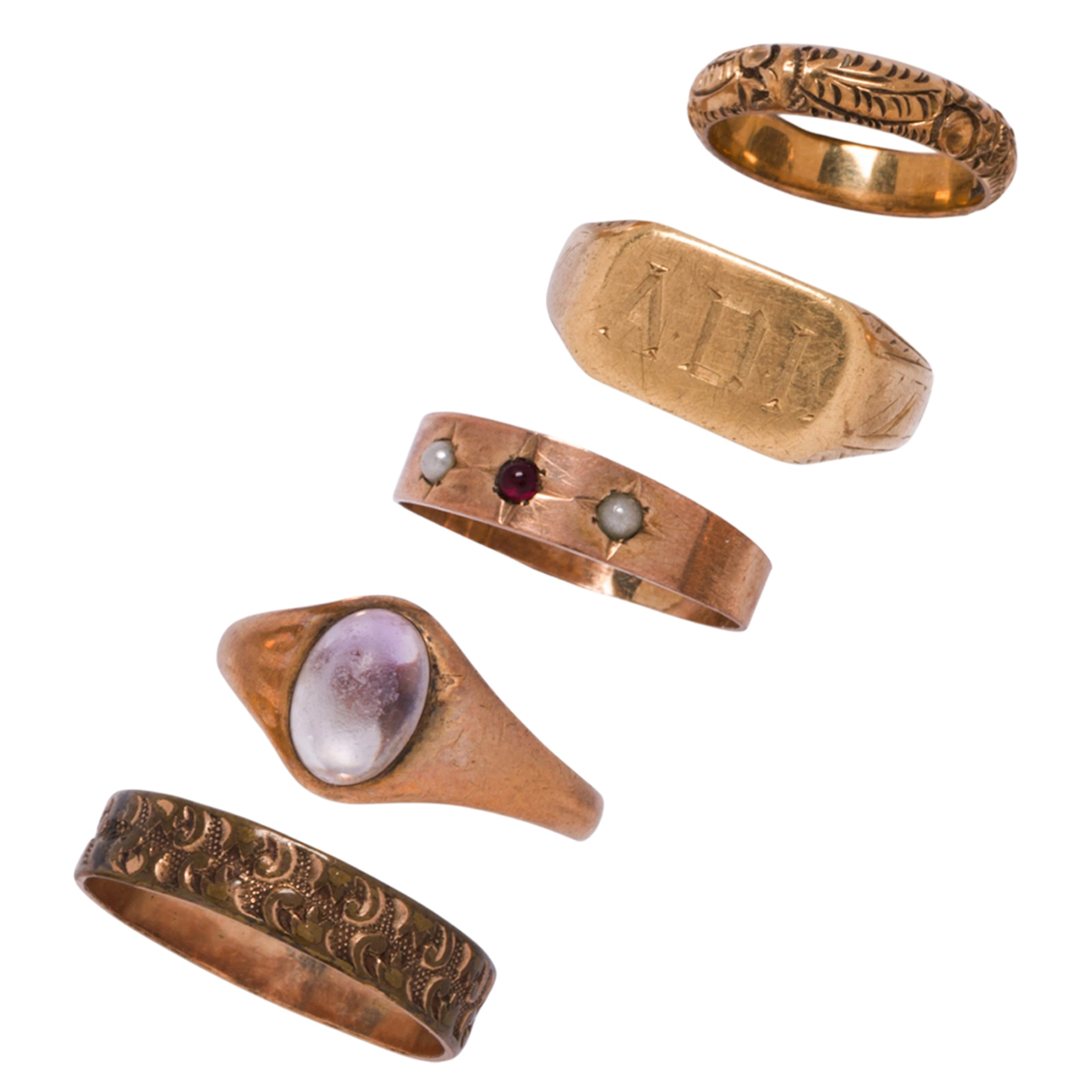 A group of gold baby rings