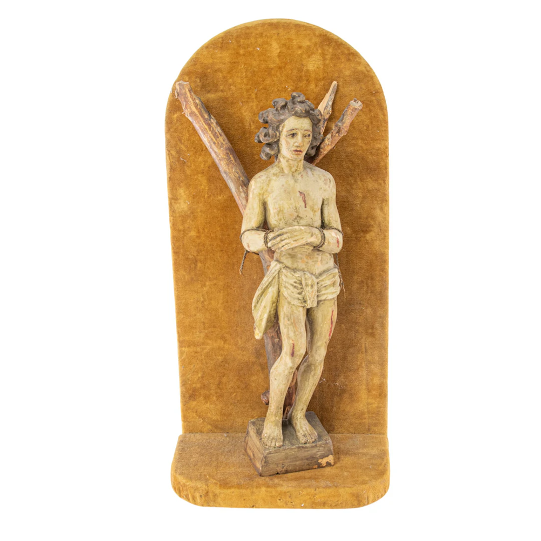 A Continental polychrome carved wood figure of St. Sebastian