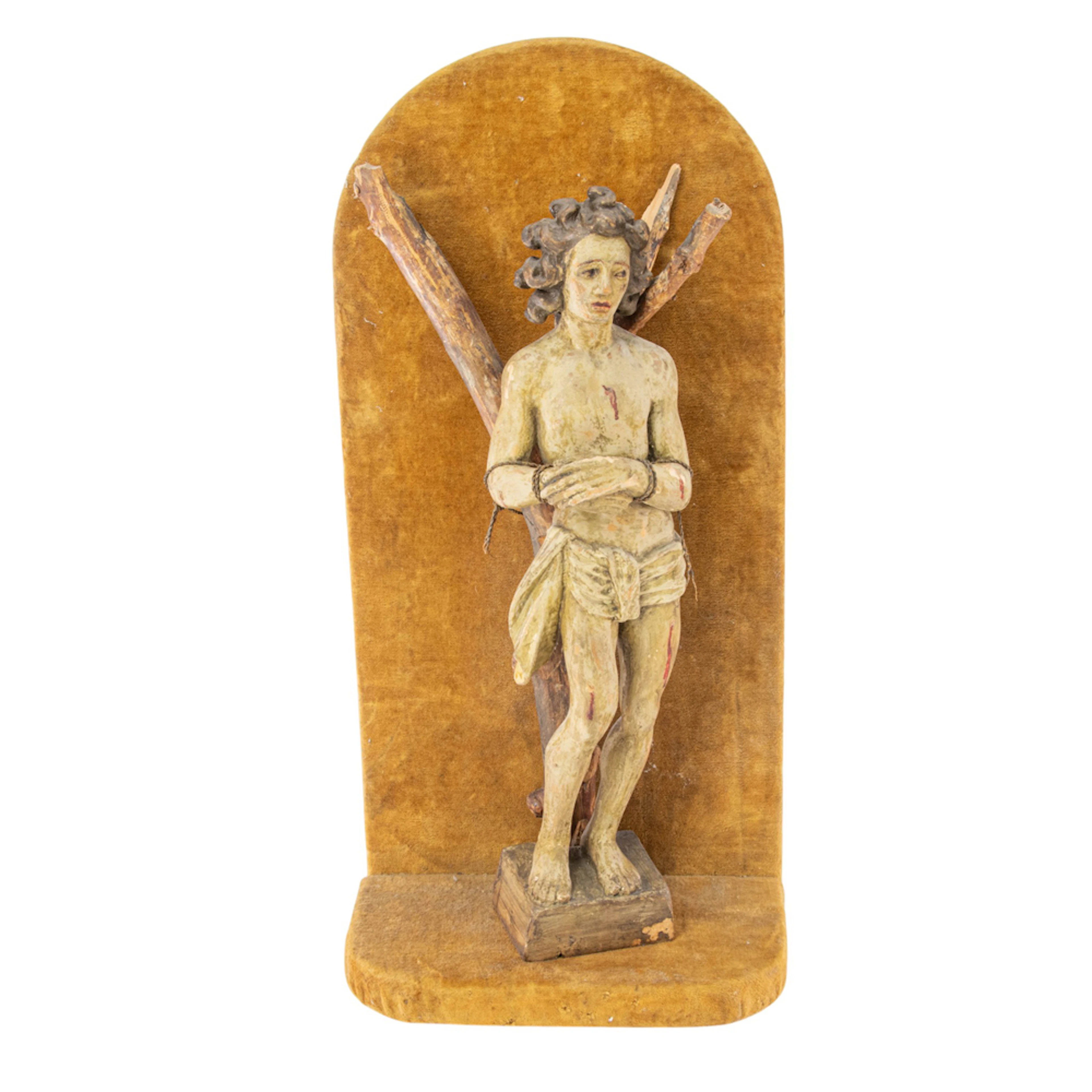 A Continental polychrome carved wood figure of St. Sebastian