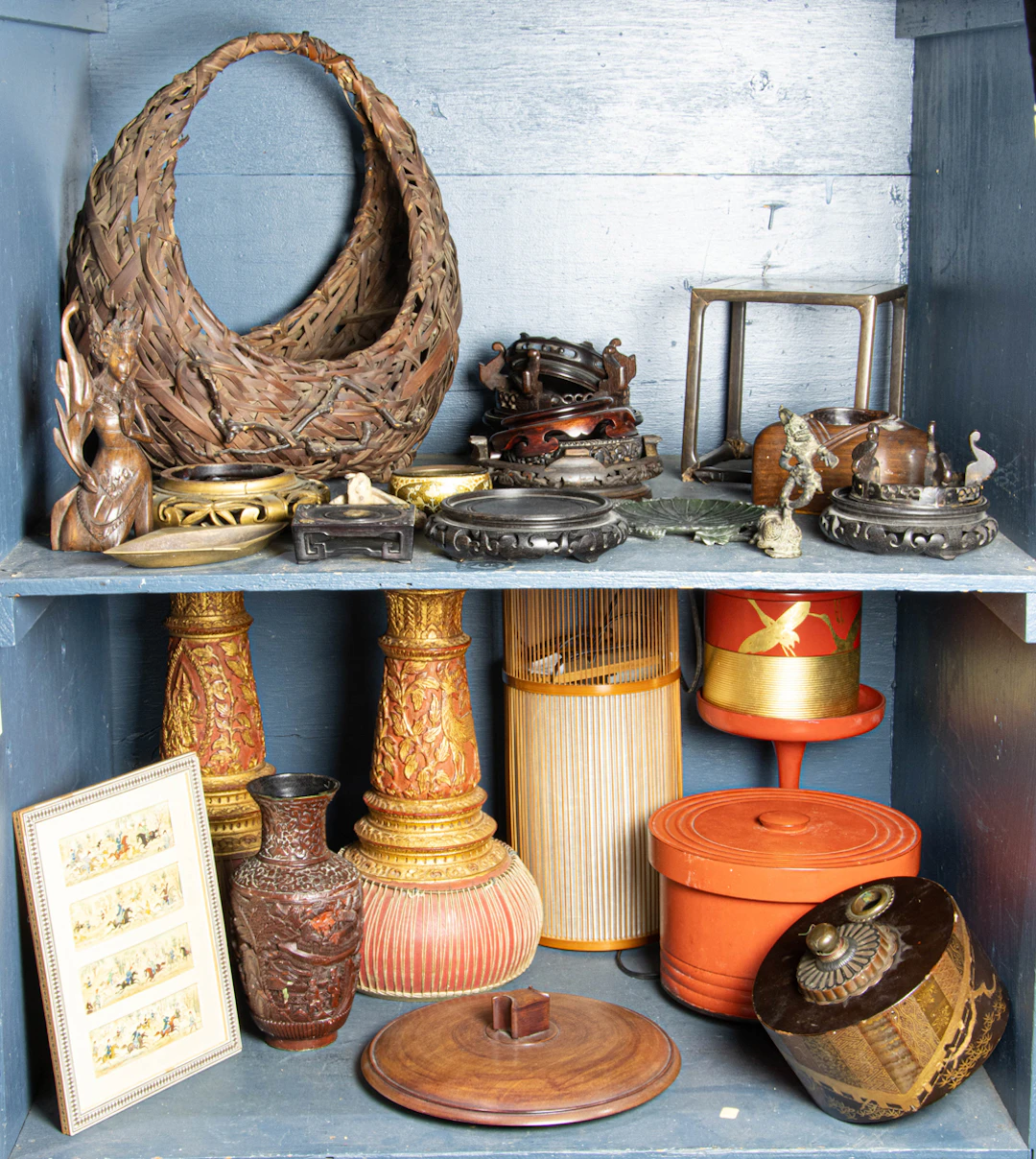 Three shelves of Asian decorative arts