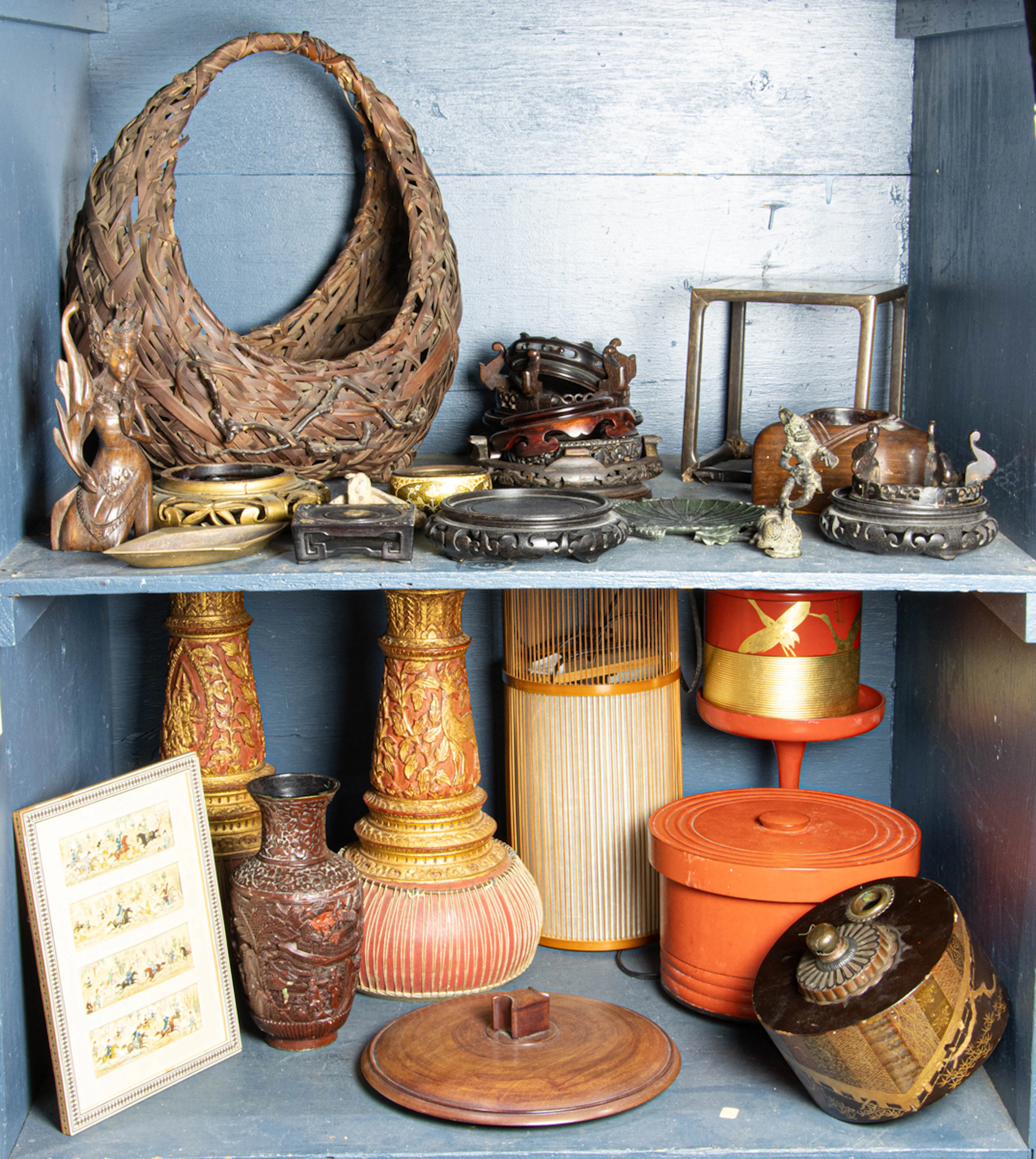 Three shelves of Asian decorative arts