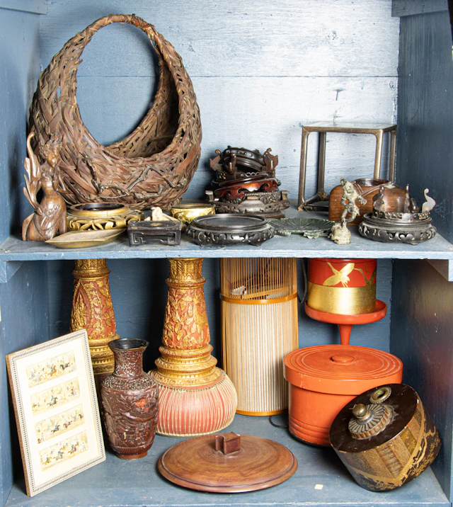 Three shelves of Asian decorative arts