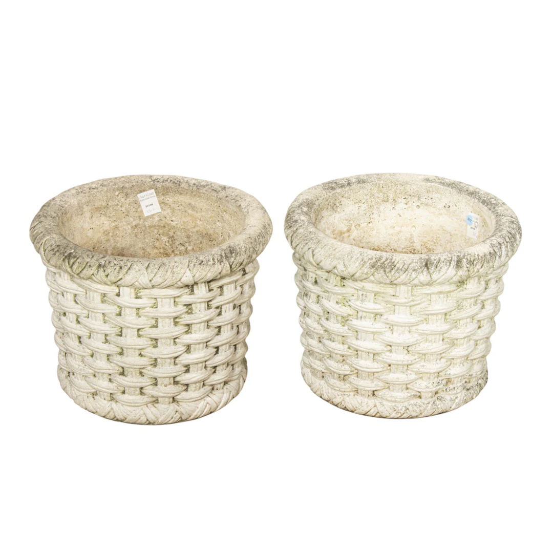 A pair of cast stone garden planters with basket weave design