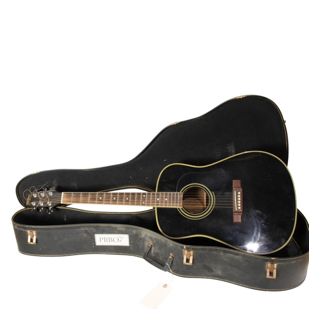 A Washburn black acoustic guitar in case