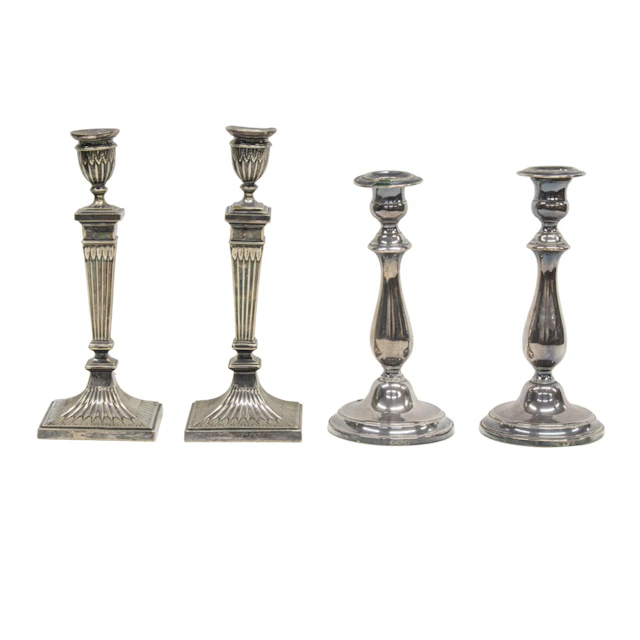 A silver plated group of two pairs of candlesticks