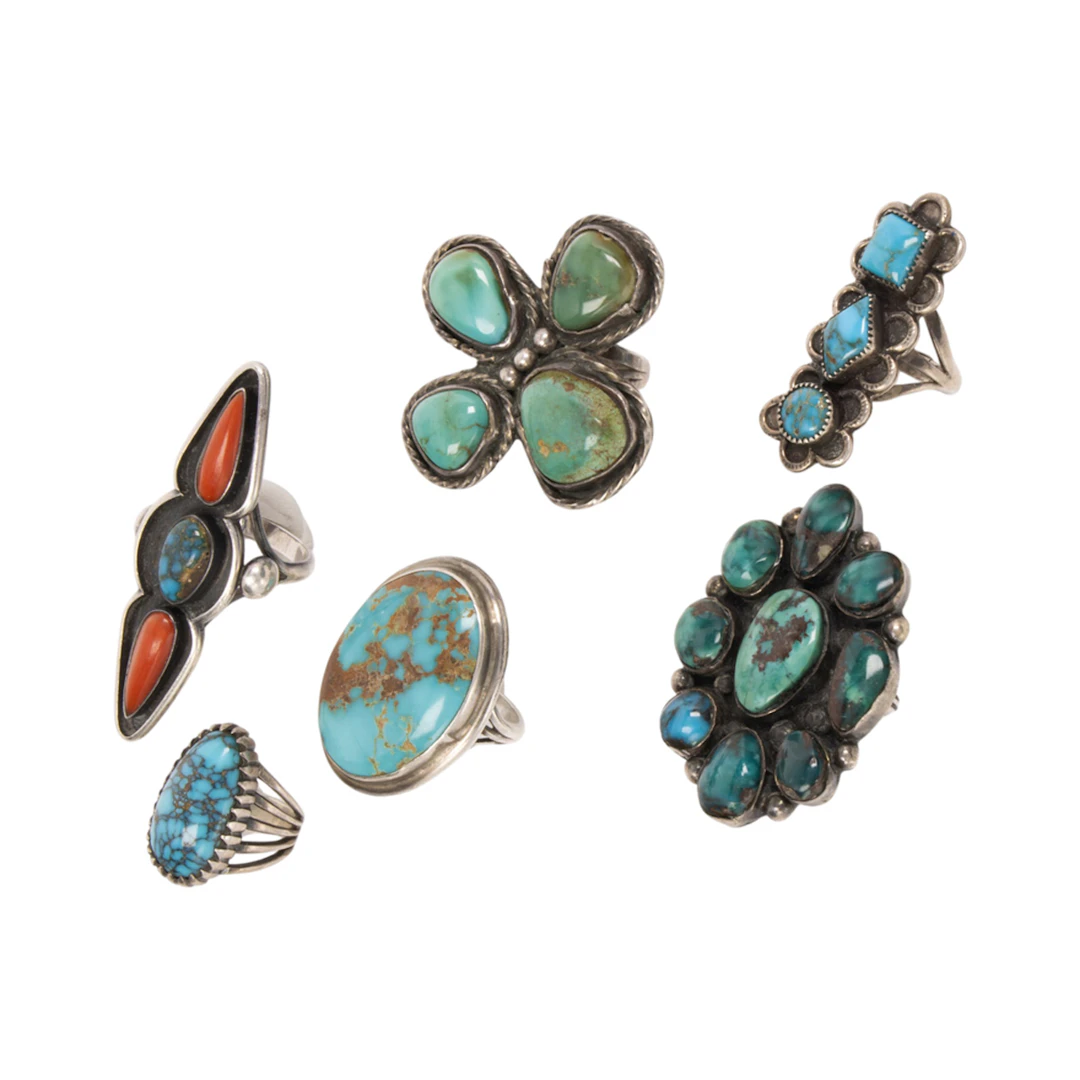 A group of Native American turquoise, coral and silver rings