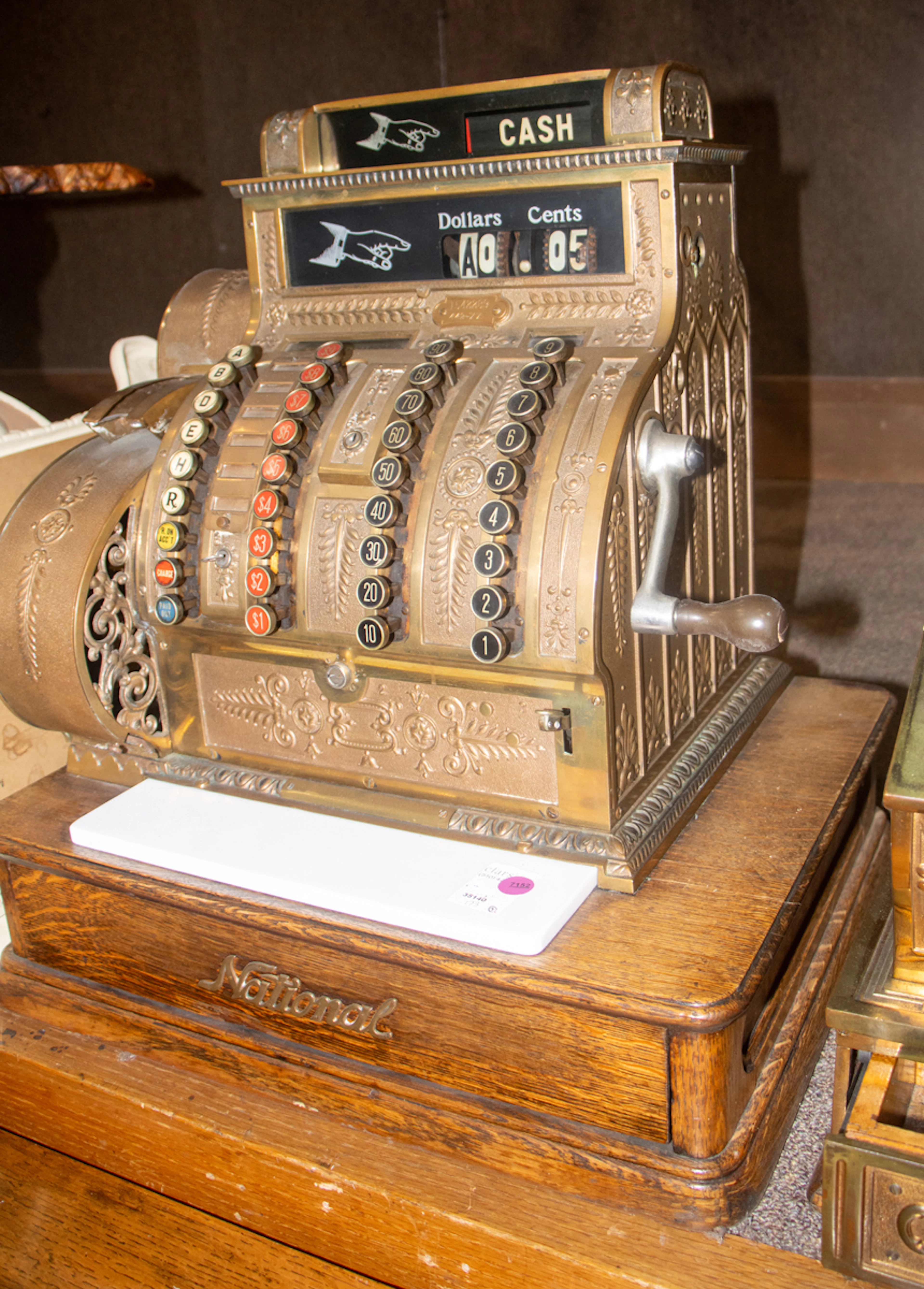 A National brass cash register on oak base