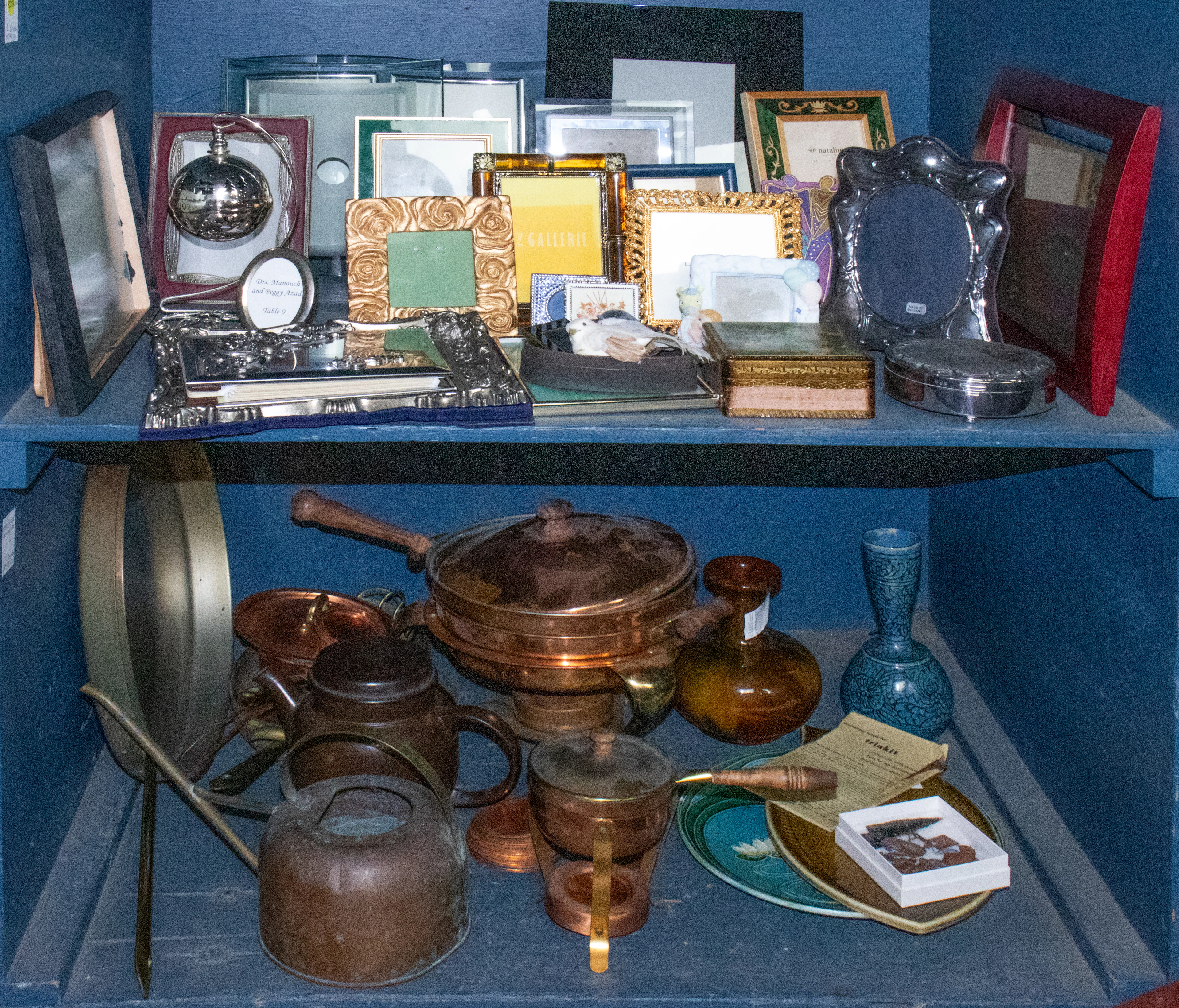 An assembled group of copperware and ceramics, including copper cooking pans